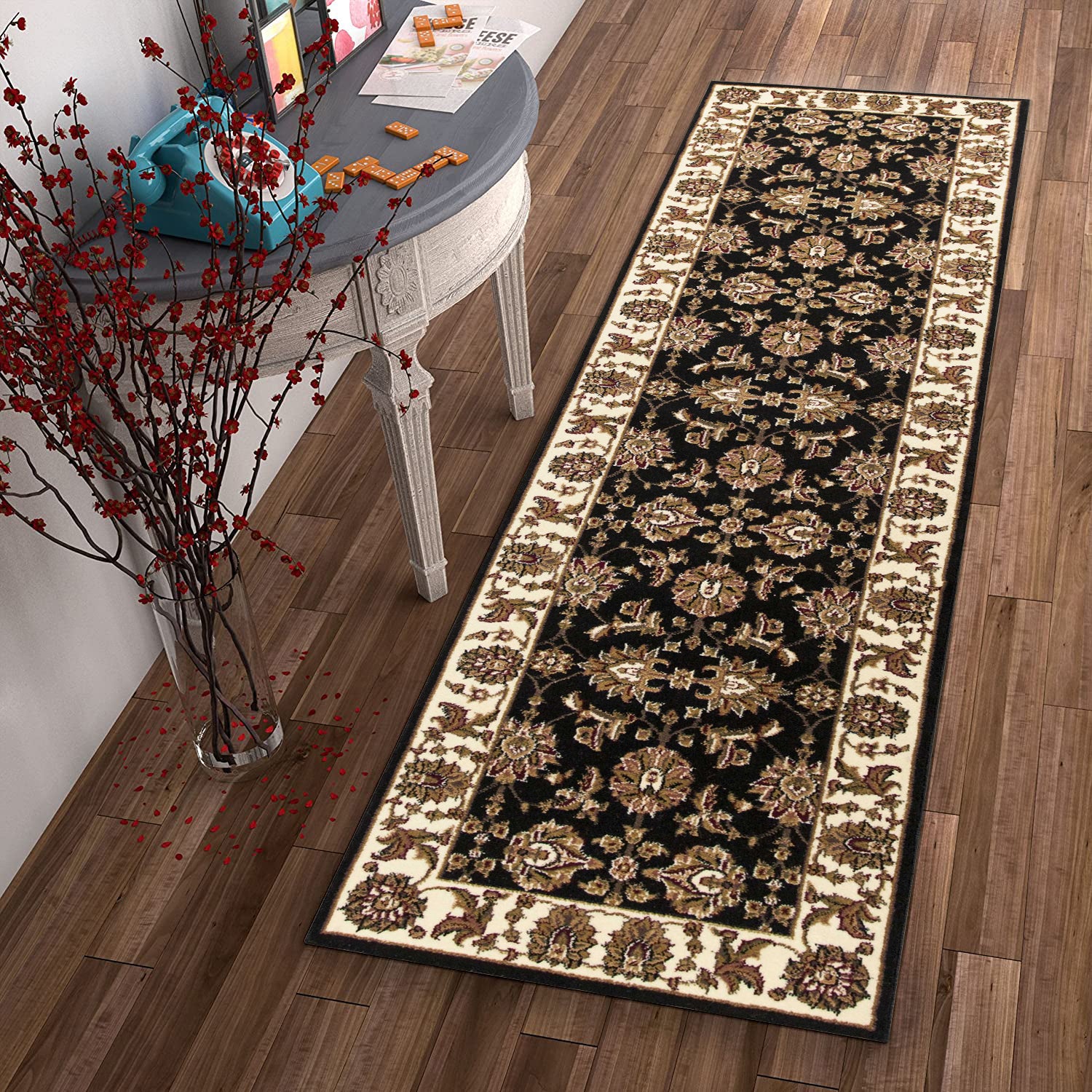 A beautiful 2x8 inches traditional bordered rug in black and ivory, showcasing intricate patterns and high-quality polypropylene material.