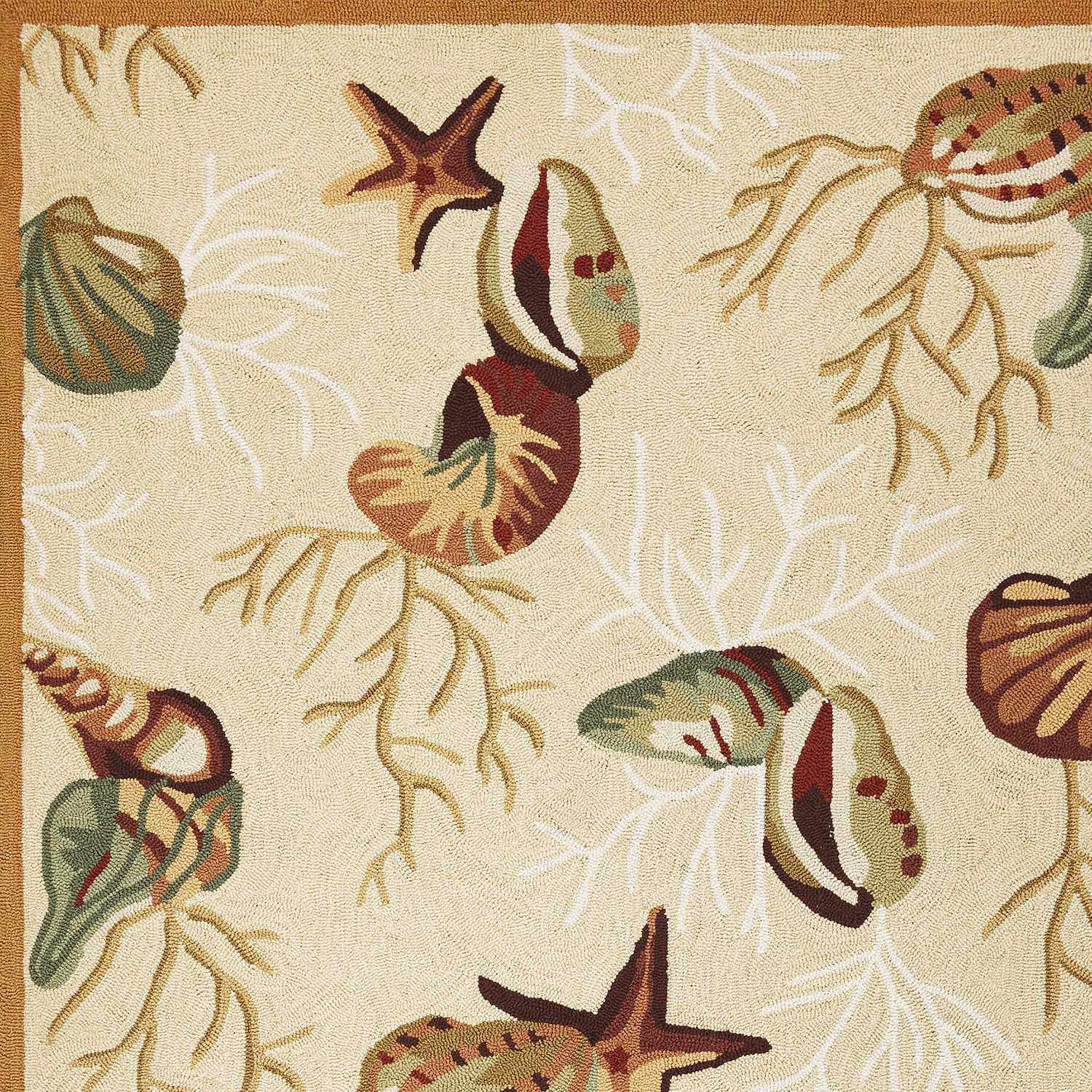 Beige hand hooked indoor accent rug featuring intricate sea shell designs, perfect for enhancing home decor.