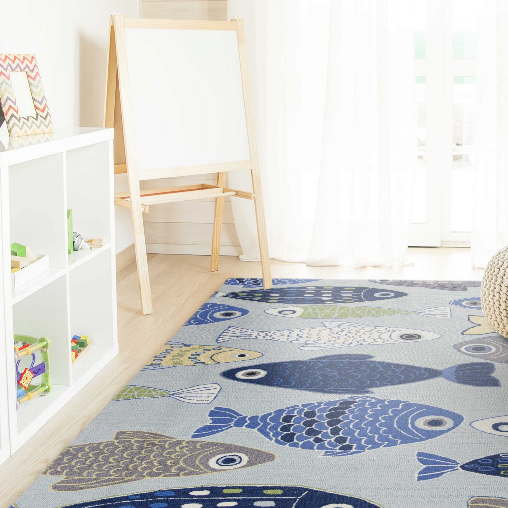 Light blue hand hooked oversized rug featuring a sea of fish design, perfect for indoor use in living rooms.