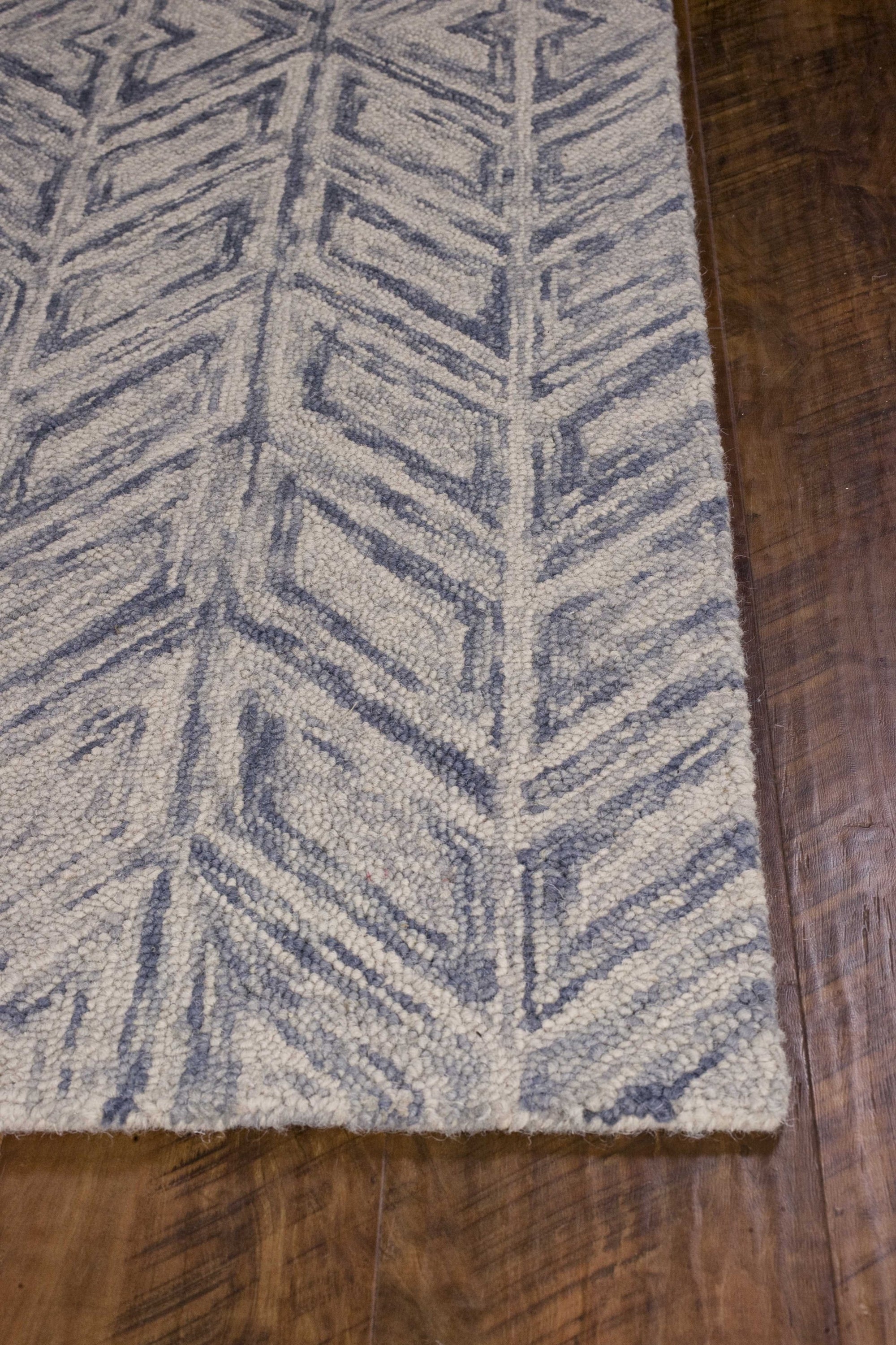 A beautiful blue hand tufted herringbone indoor accent rug, showcasing a modern design and high-quality wool material.