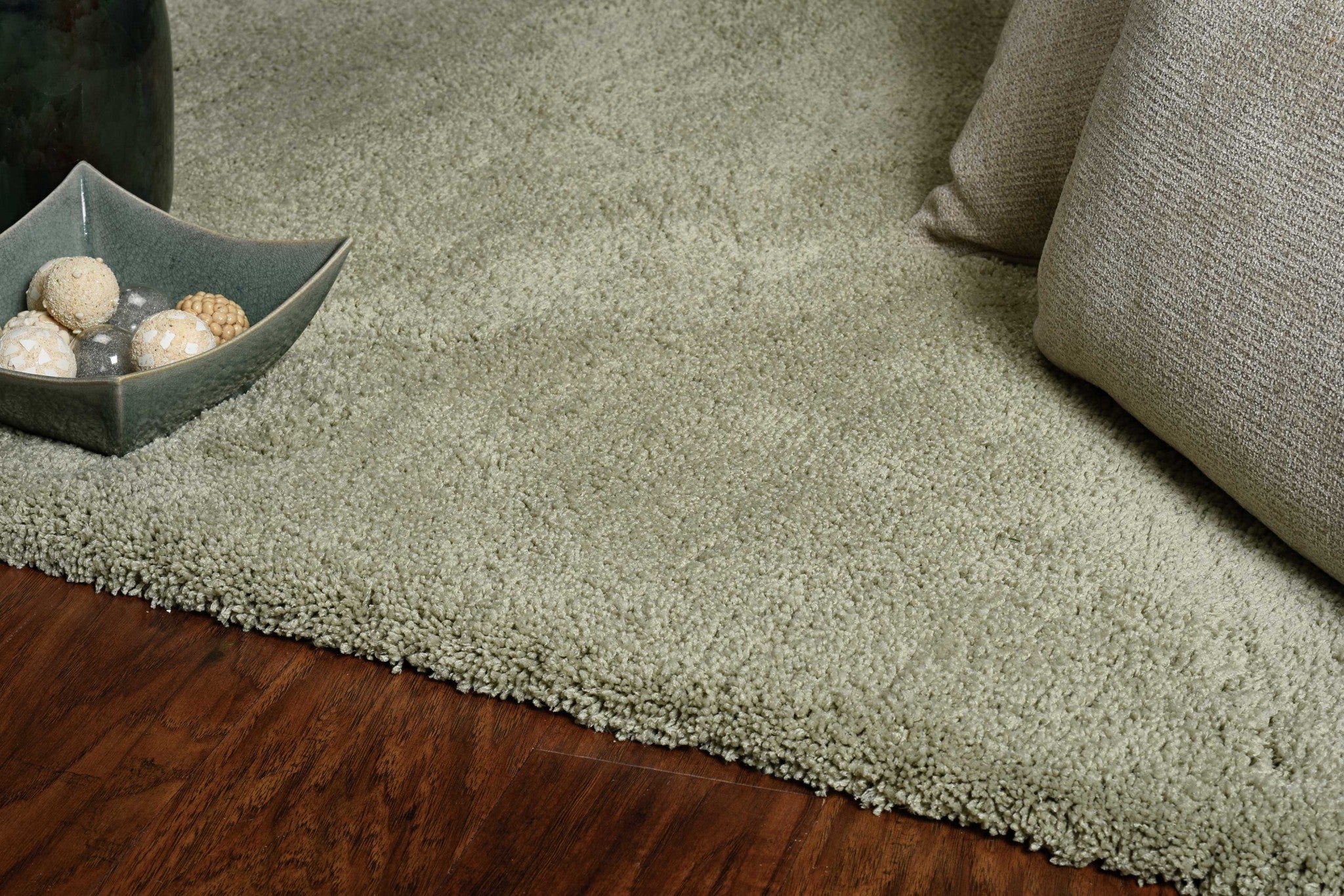 A beautiful sage green indoor shag rug measuring 2x4 feet, showcasing a soft texture and contemporary design, perfect for enhancing home decor.
