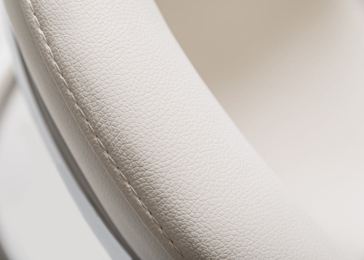 30-inch white leatherette dining chair with stainless steel legs, showcasing a modern and elegant design suitable for dining rooms.