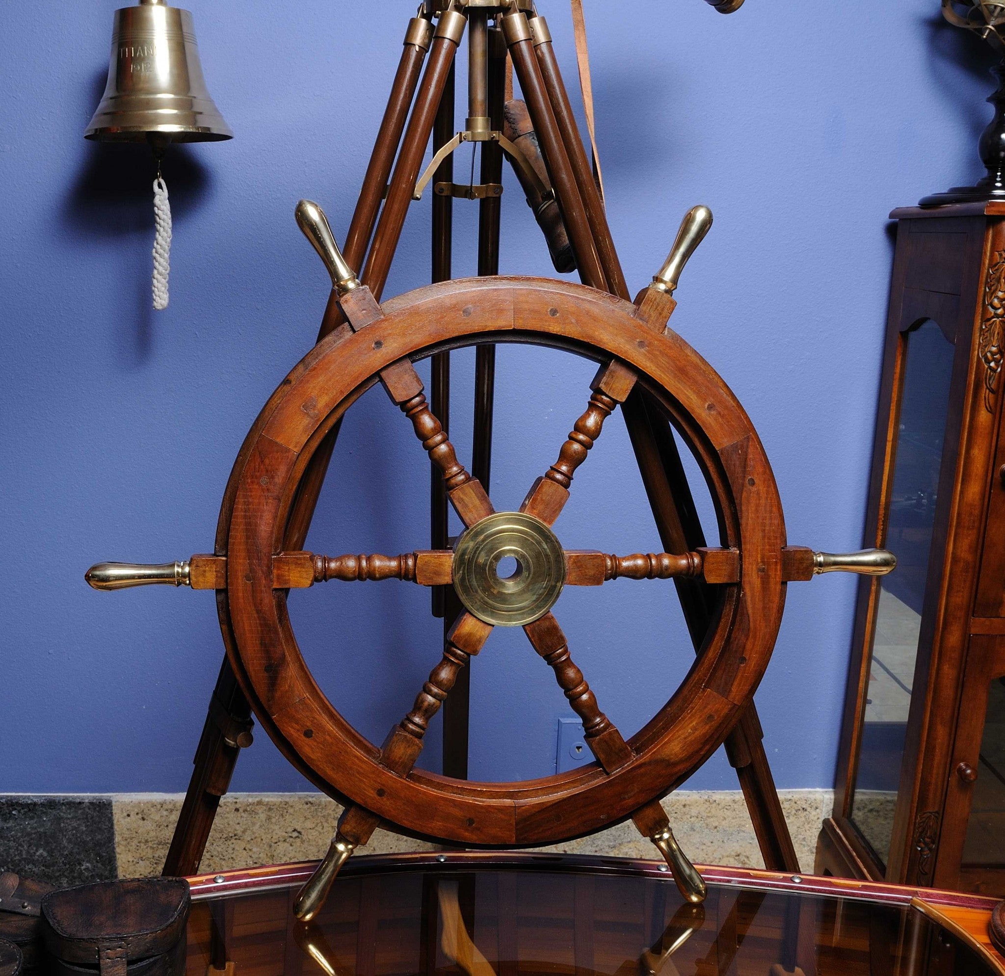 A beautifully crafted 30-inch ship wheel made from rosewood with a brass hub and handles, showcasing a shiny natural finish.