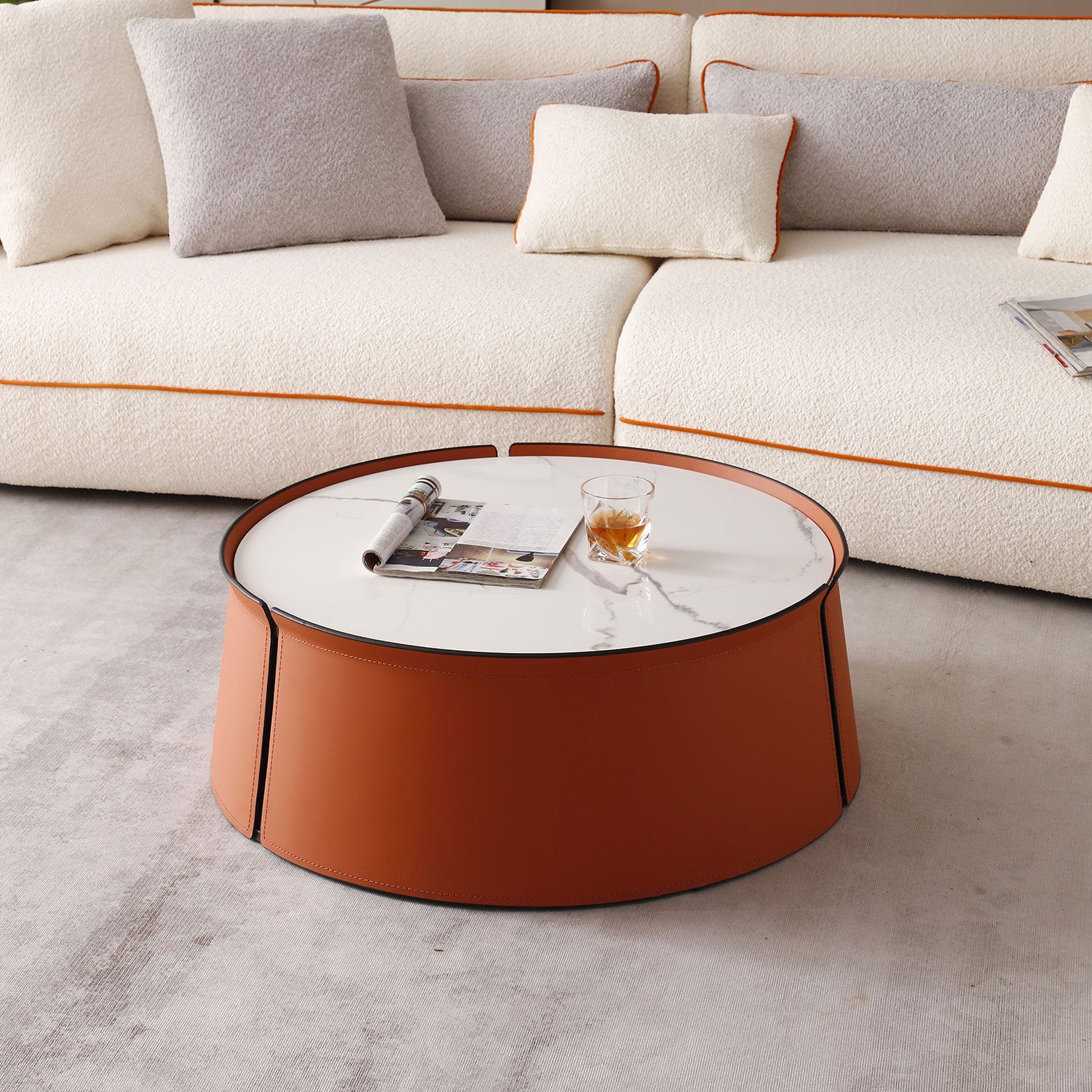 A stylish 31.5-inch coffee table featuring a luxurious marble top, vibrant orange saddle leather body, and a sturdy iron frame, perfect for modern living spaces.