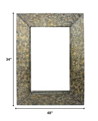 A rectangular dressing mirror with a bronze gravel-like mosaic frame, showcasing a coastal style perfect for home decor.