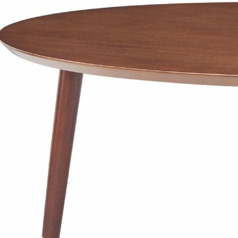 Walnut mid-century modern coffee table with round top and tapered legs, showcasing intricate design and rich wood finish.