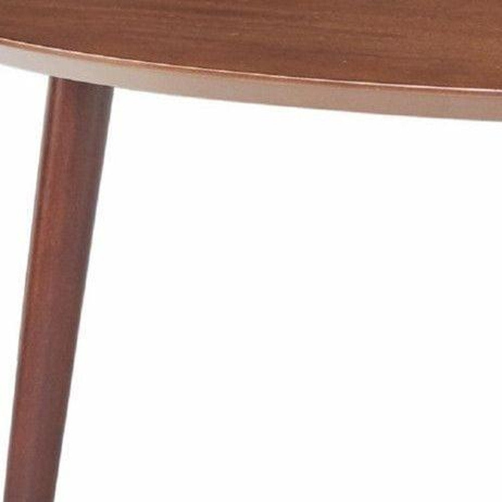 Walnut mid-century modern coffee table with round top and tapered legs, showcasing intricate design and rich wood finish.