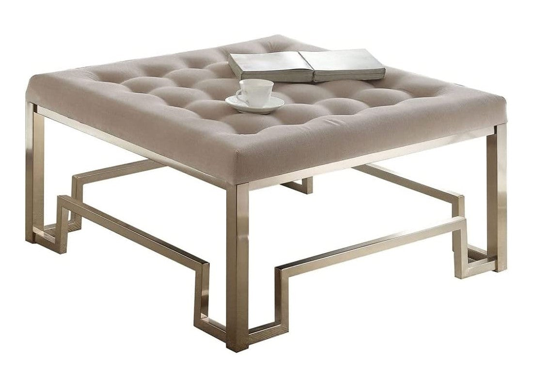 36x36x18 fabric champagne cocktail ottoman with button-tufted cushion and geometric metal base in champagne finish.