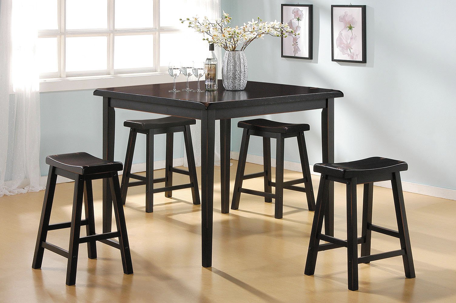 5-piece black rubber wood counter height dining set with oak finish tabletop and backless stools.