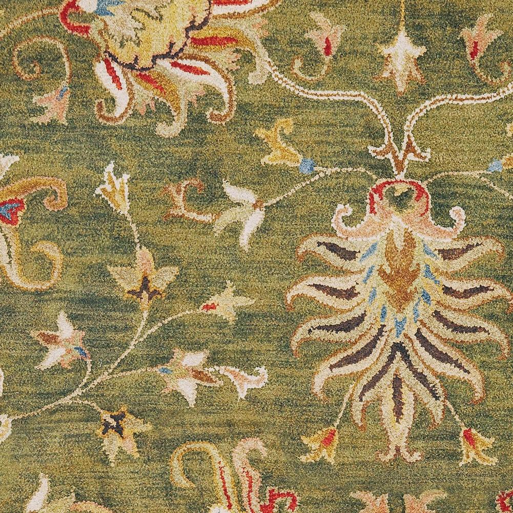 Emerald green hand-tufted wool rug featuring a traditional floral design, perfect for enhancing indoor decor.