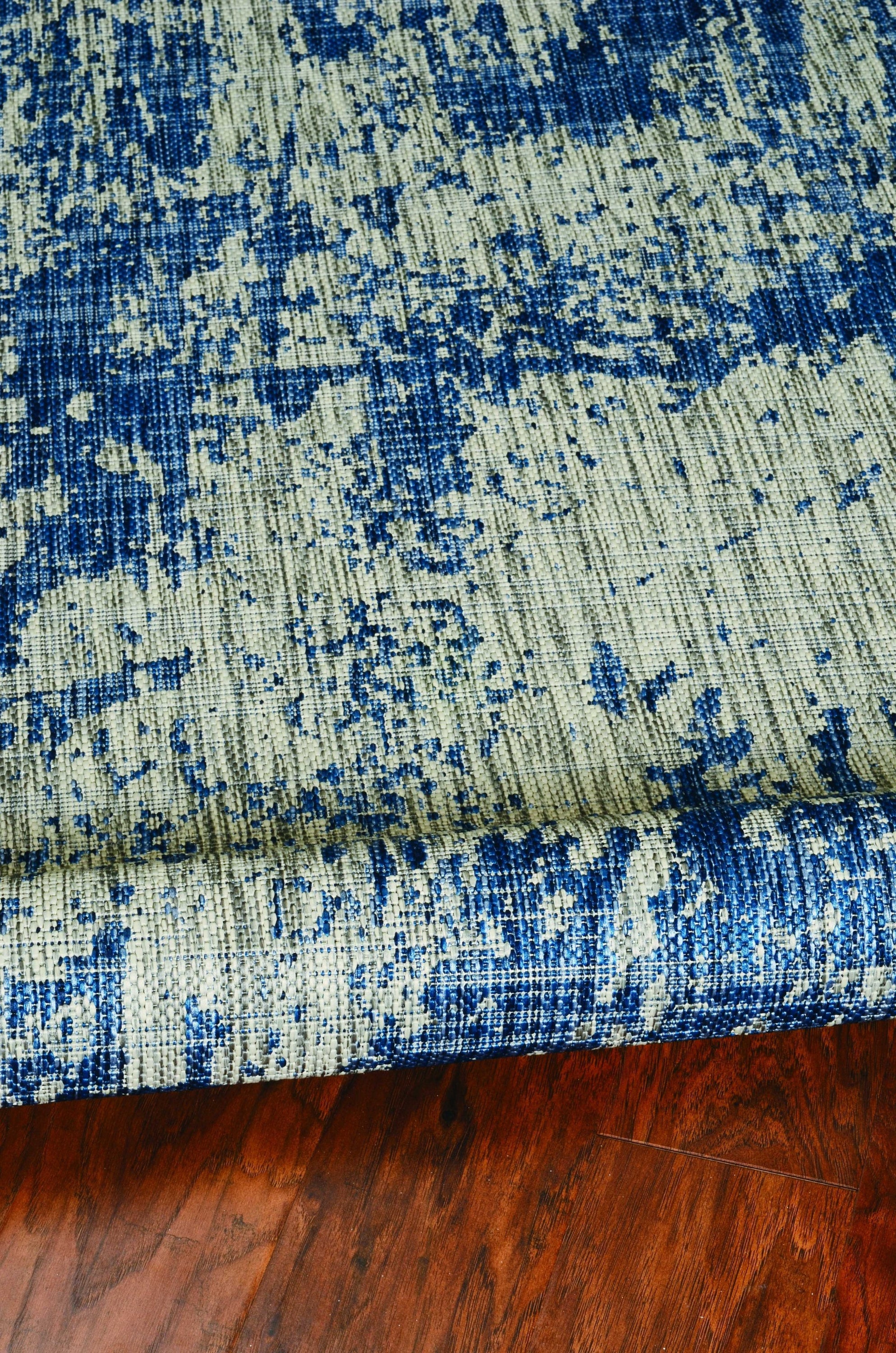 A stylish grey denim rug with abstract strokes, perfect for indoor and outdoor use, showcasing modern design and quality craftsmanship.