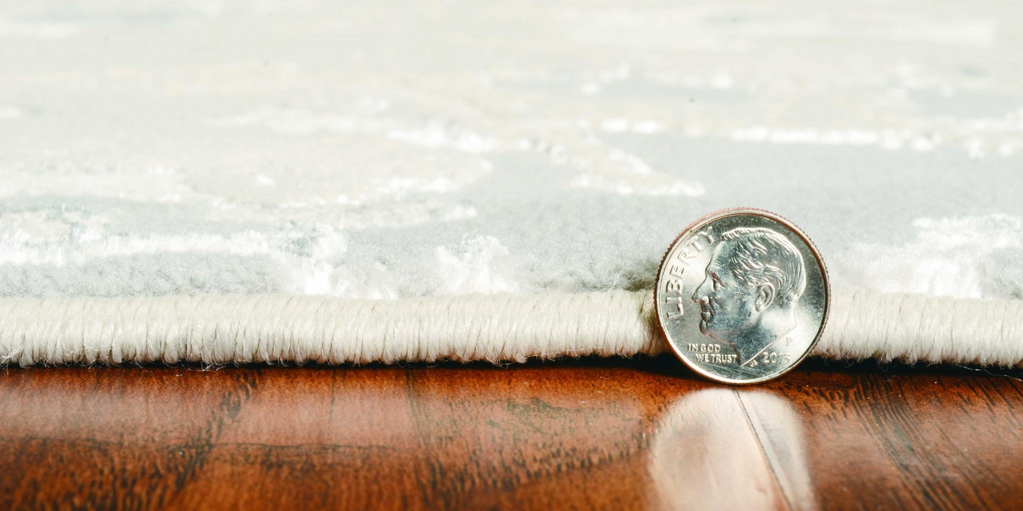 Sand grey machine woven abstract watercolor indoor rug, showcasing a modern design with paint-dripping effects.