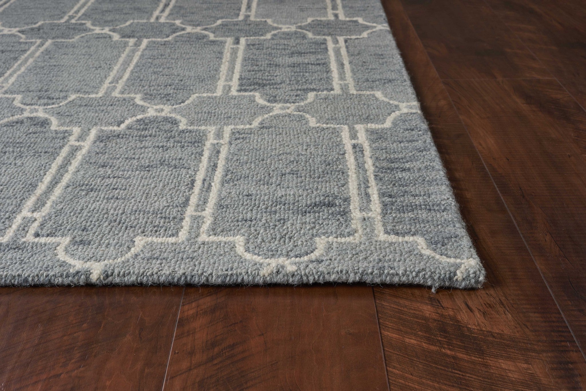 A beautiful slate blue hand-tufted geometric indoor area rug, showcasing modern patterns and a soft wool texture, perfect for enhancing home decor.