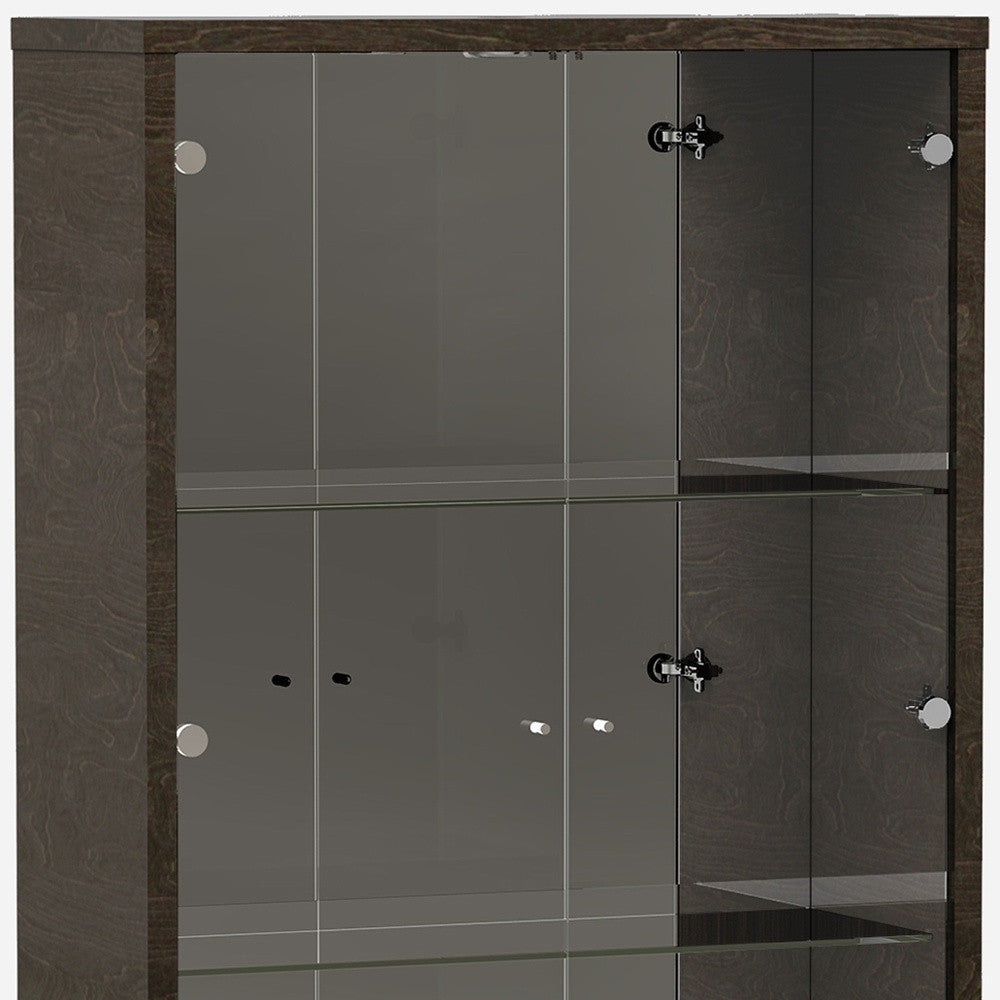 A tall gray vetrine with glass doors, three shelves, and a bottom drawer, showcasing modern design and high gloss finish.