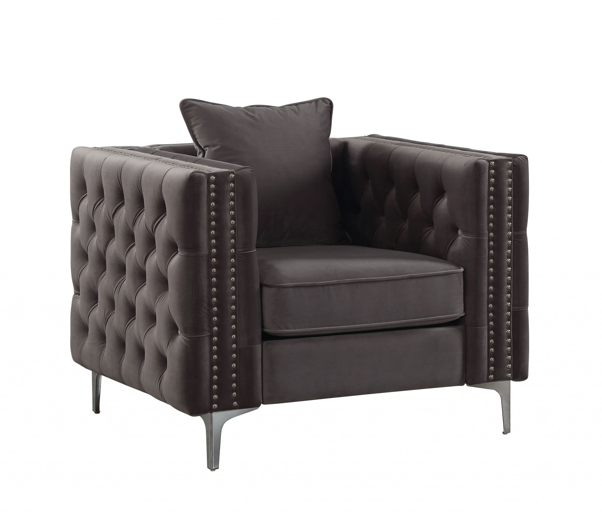 A stylish dark gray velvet chair with button tufted design and an accent pillow, resting on chrome metal bracket legs.