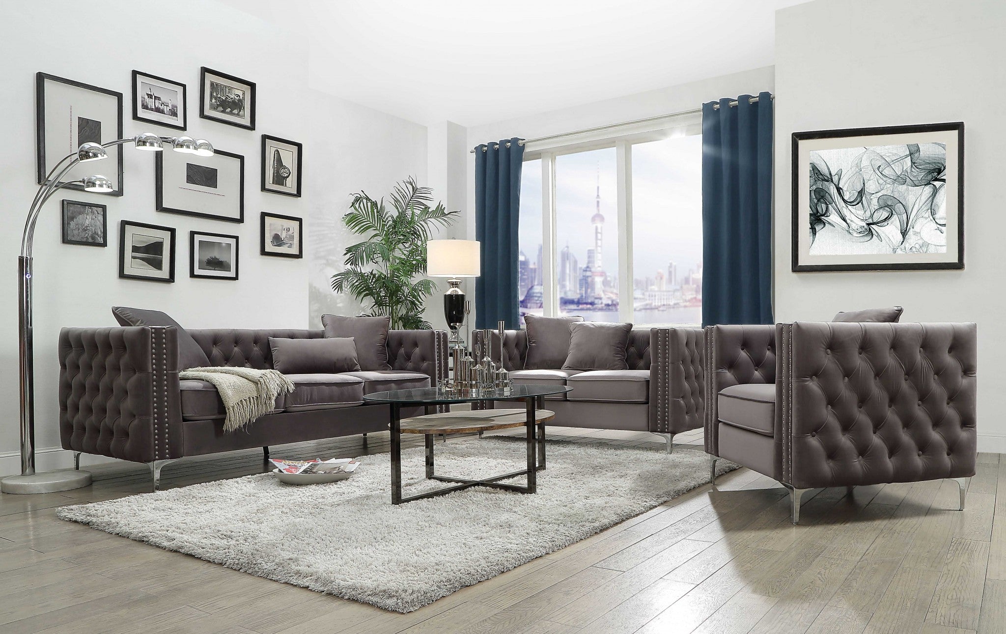 A stylish dark gray velvet chair with button tufted design and an accent pillow, resting on chrome metal bracket legs.