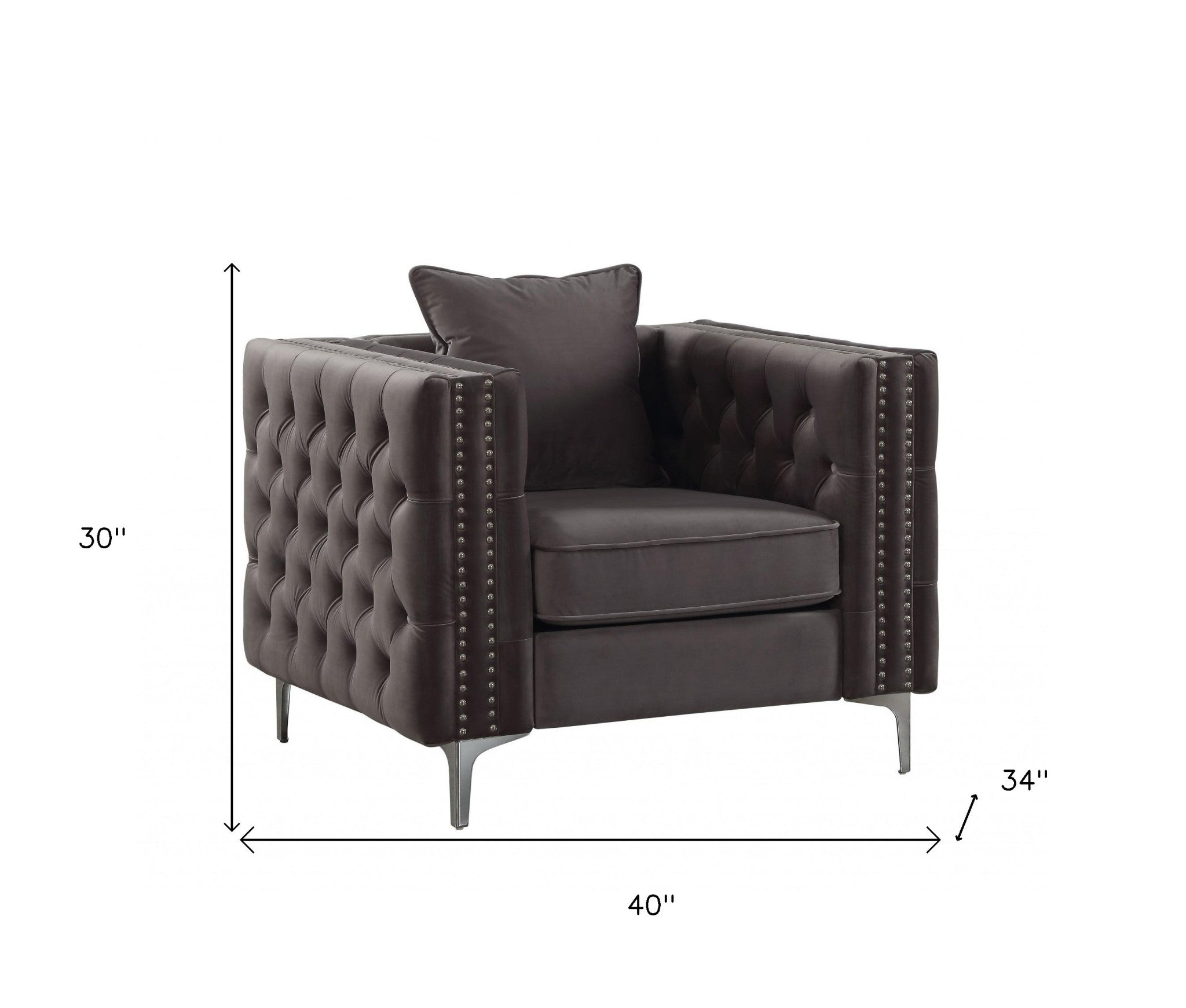 A stylish dark gray velvet chair with button tufted design and an accent pillow, resting on chrome metal bracket legs.