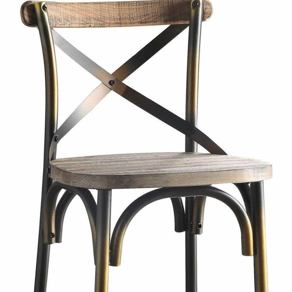 A vintage style bar chair featuring an antiqued copper and oak finish, with a simple 'X' style backrest and a wooden seat.