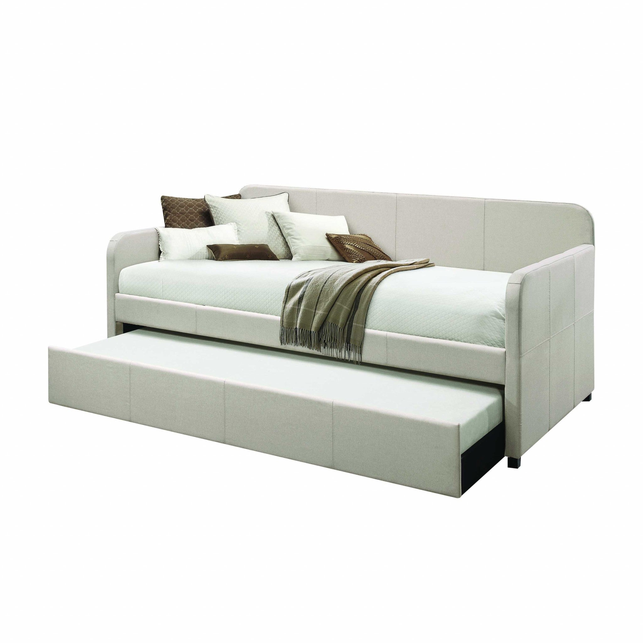 A stylish 43x82 inches fabric upholstered daybed with wood legs, featuring a beige upholstery and a convenient tuck-away trundle bed.