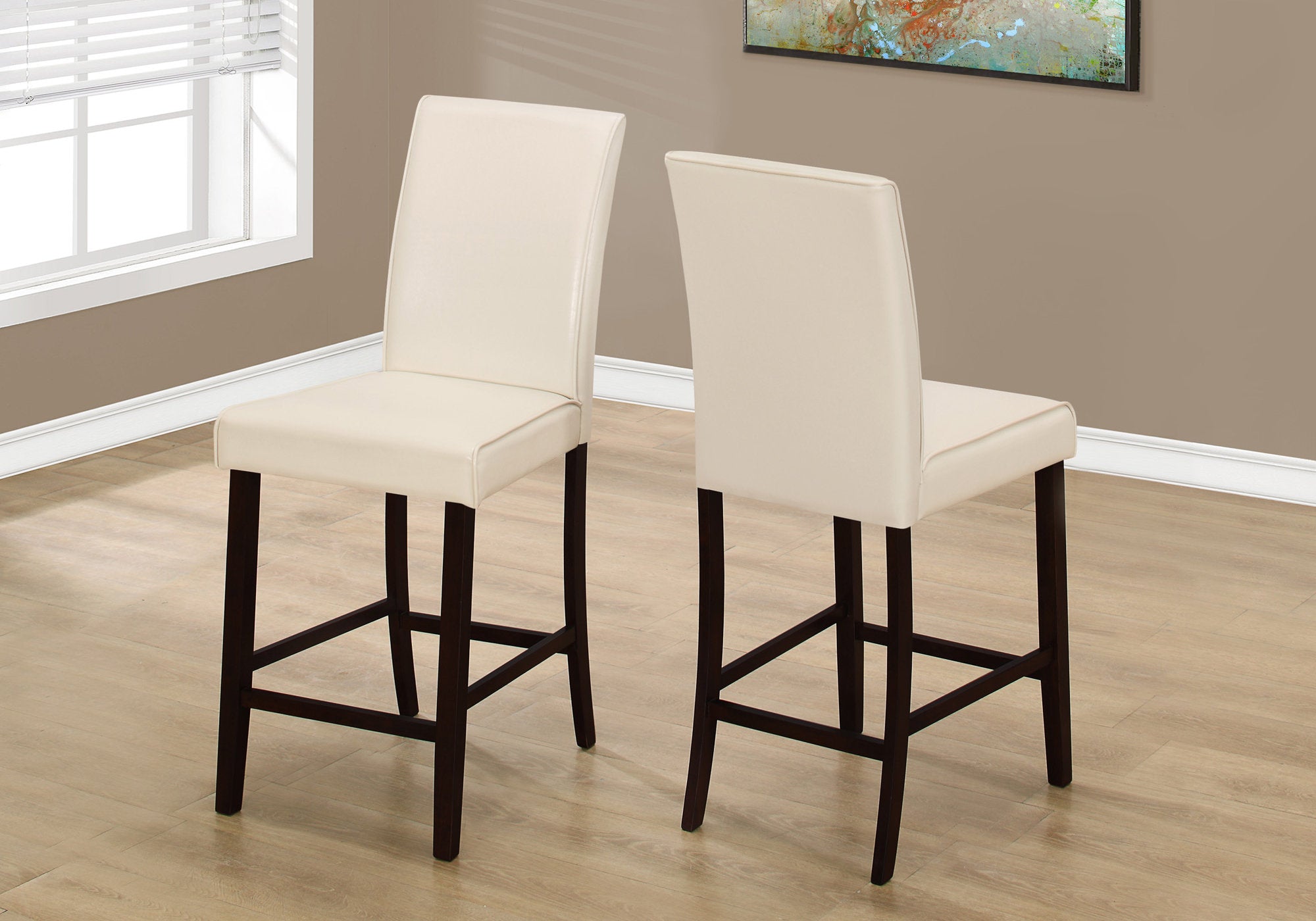 Set of two brown leather look counter height dining chairs, showcasing elegant design and sturdy construction, perfect for dining rooms.