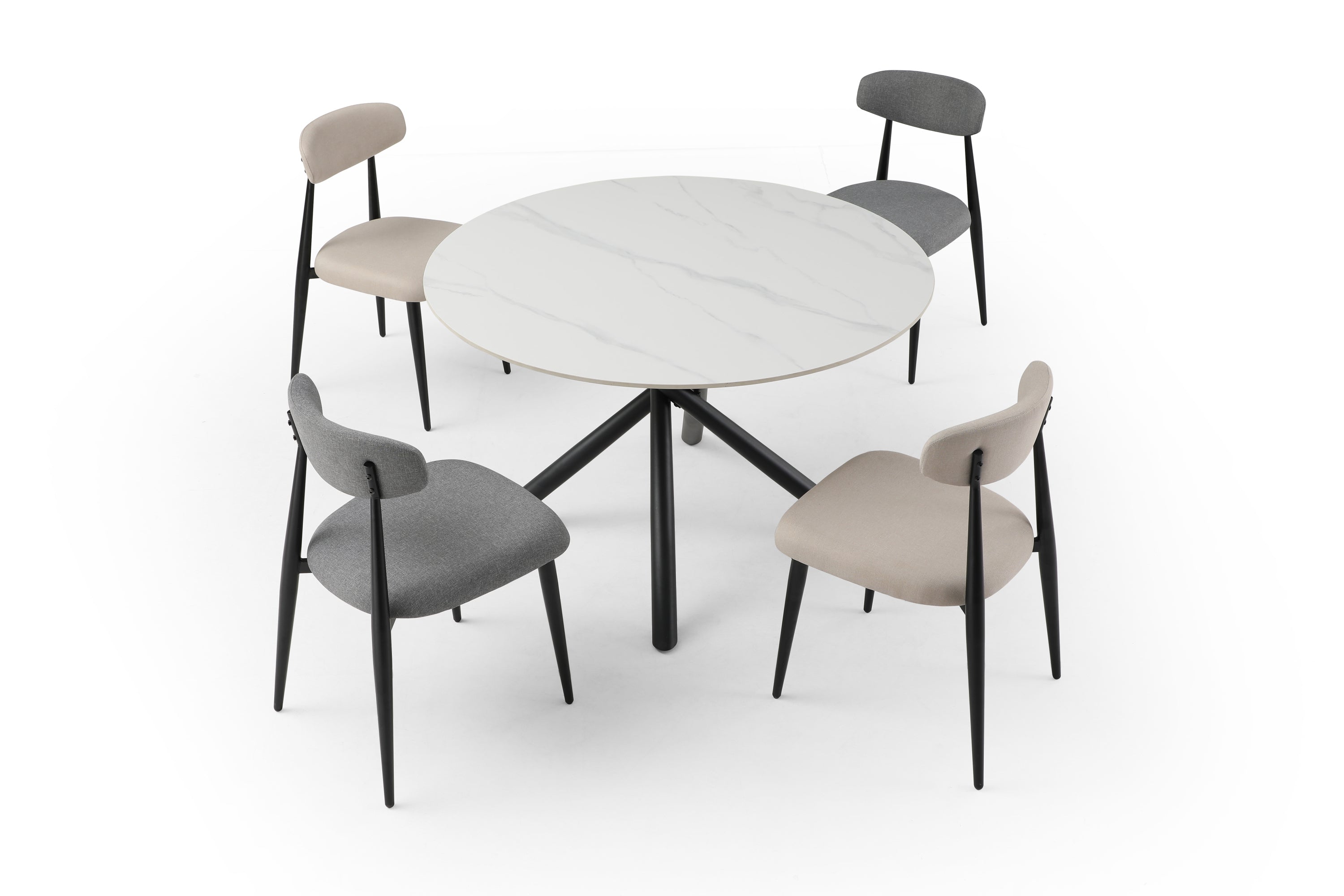 A modern round dining table with a white sintered stone tabletop and sturdy metal cross legs, perfect for contemporary dining spaces.