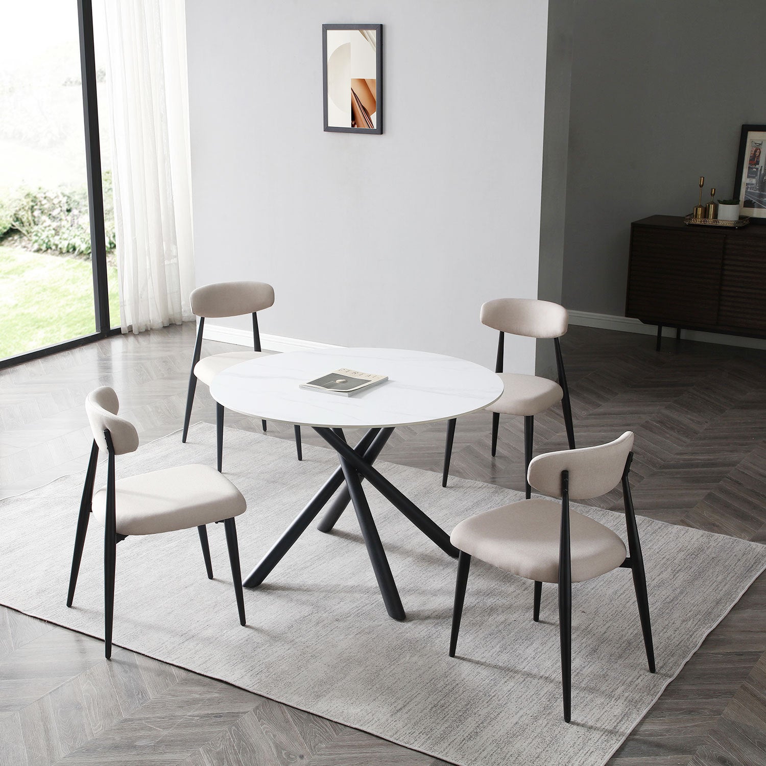 A modern round dining table with a white sintered stone tabletop and sturdy metal cross legs, perfect for contemporary dining spaces.