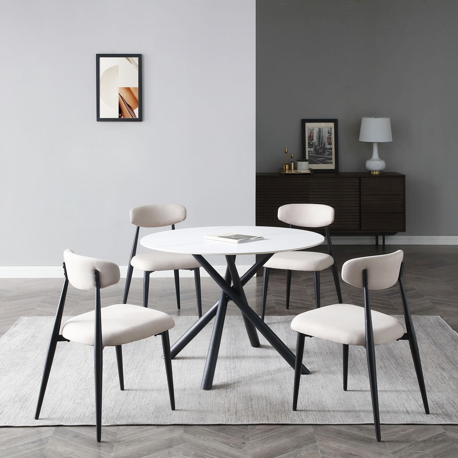 A modern round dining table with a white sintered stone tabletop and sturdy metal cross legs, perfect for contemporary dining spaces.