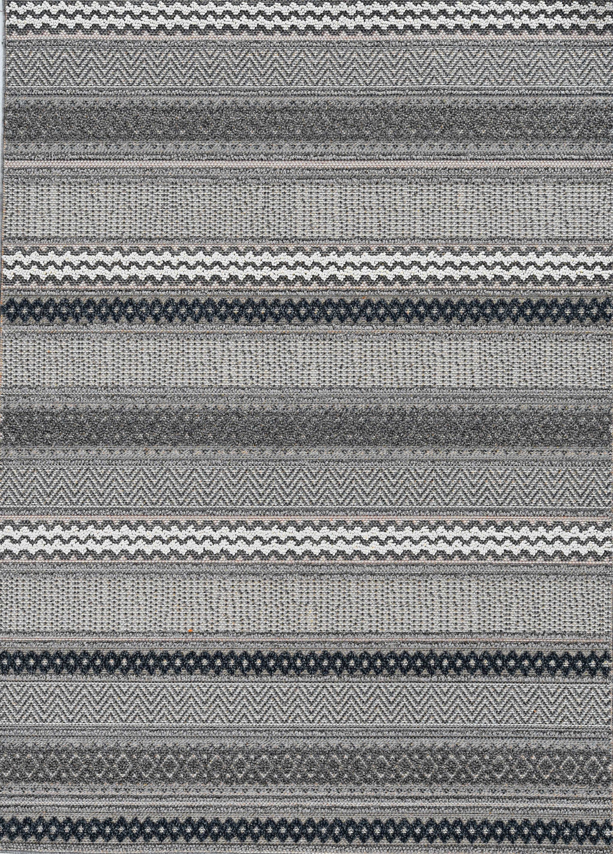 4 inches x 6 inches taupe geometric lines area rug displayed in a modern living room setting, showcasing its stylish design and texture.