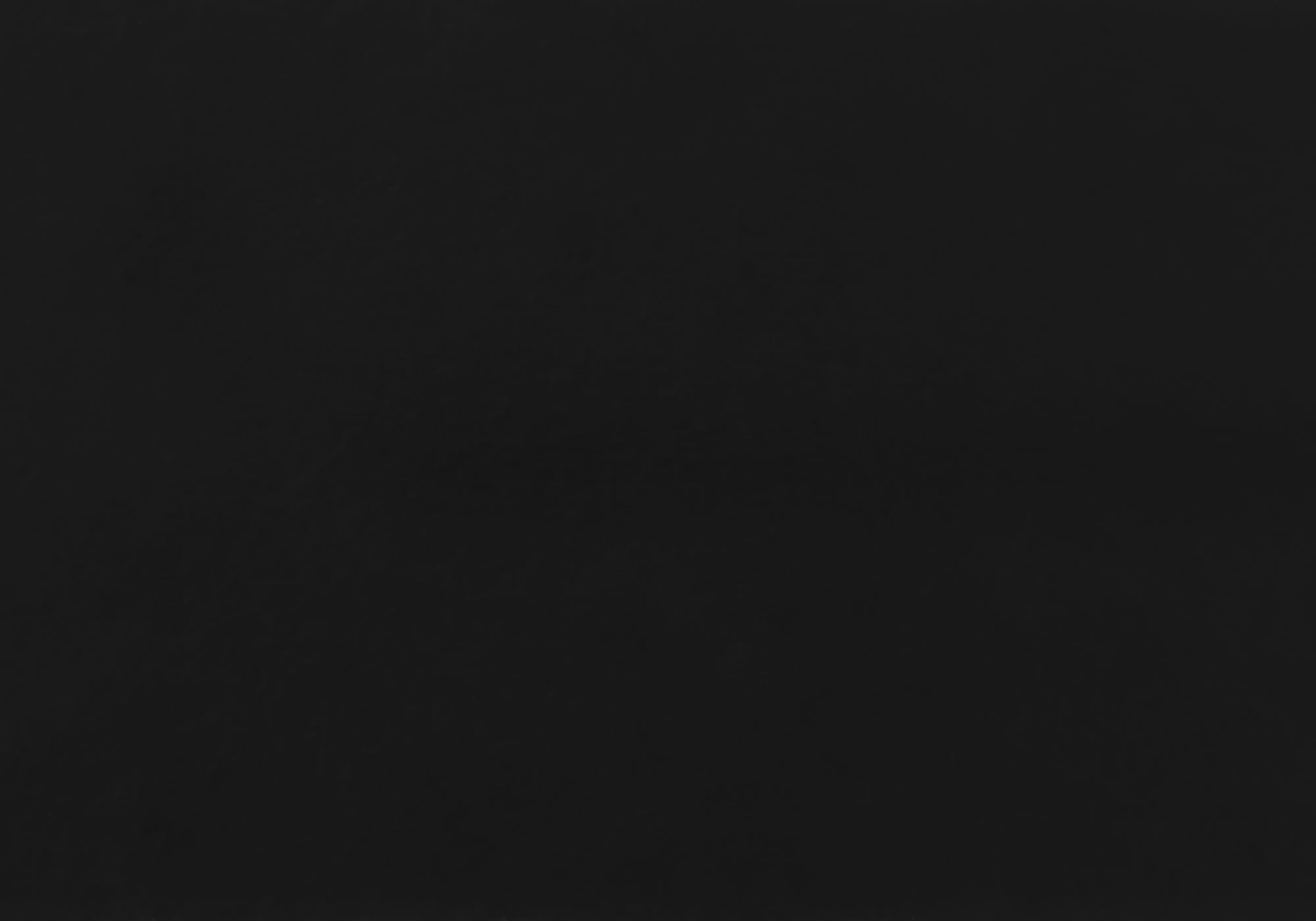 L-shaped computer desk made of black clear grey particle board, featuring two drawers and a cubby space, ideal for home or office use.