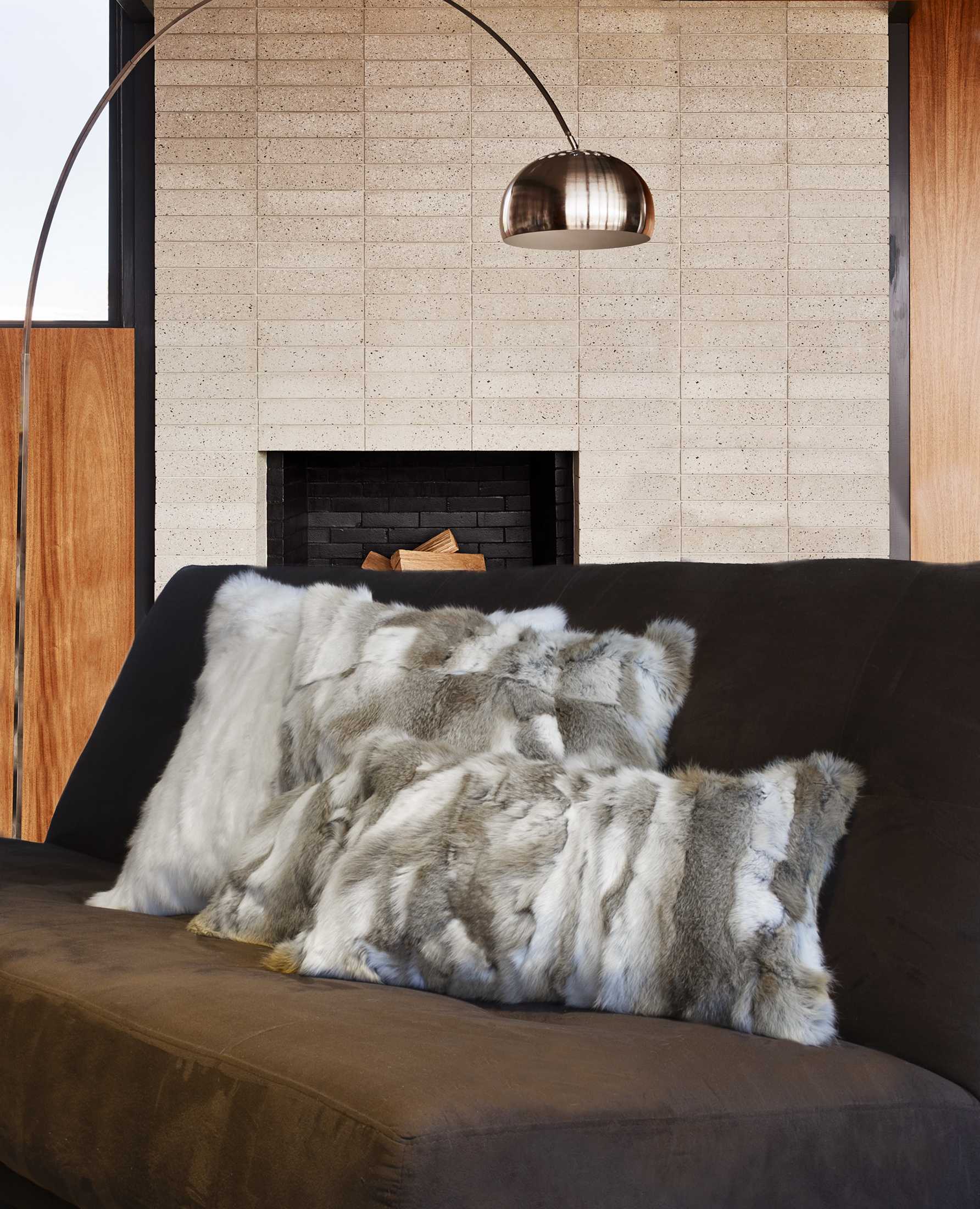 Luxurious 5x12x20 inches tan and white rabbit fur pillow, showcasing its soft texture and elegant design.