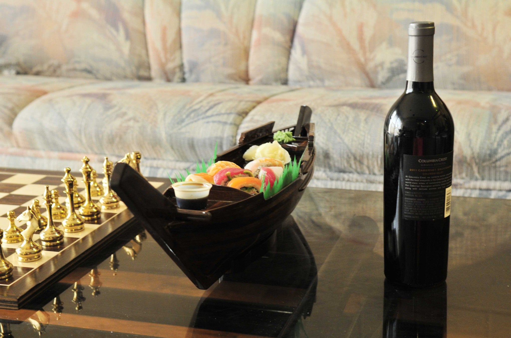 A beautifully crafted wooden sushi tray designed as a dhow boat, showcasing its unique shape and elegant finish.