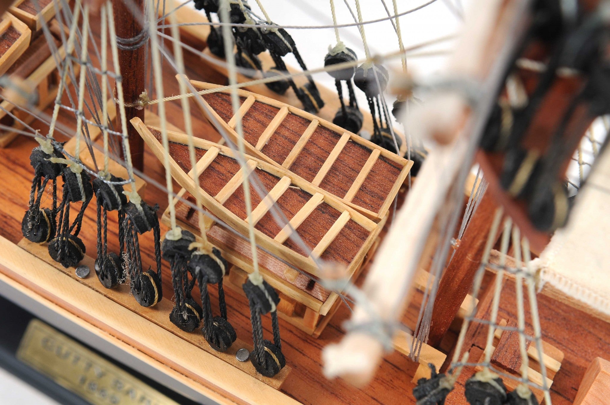 Handcrafted Small Cutty Sark model made of exotic wood with detailed features including masts, sails, and metal ornaments.