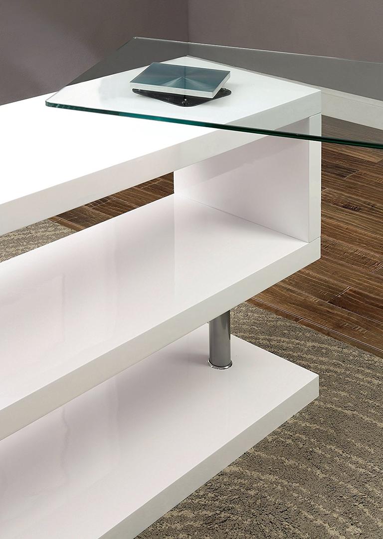 A modern black high gloss clear glass office desk featuring an L-shape design with a clear glass top and X-shape metal legs.