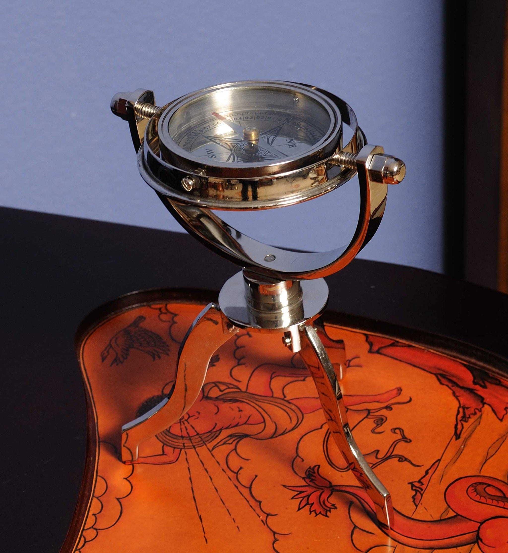 5 inches x 5 inches x 8.5 inches gimbaled compass on a solid brass tri-stand, showcasing a silver tinted finish and intricate craftsmanship.