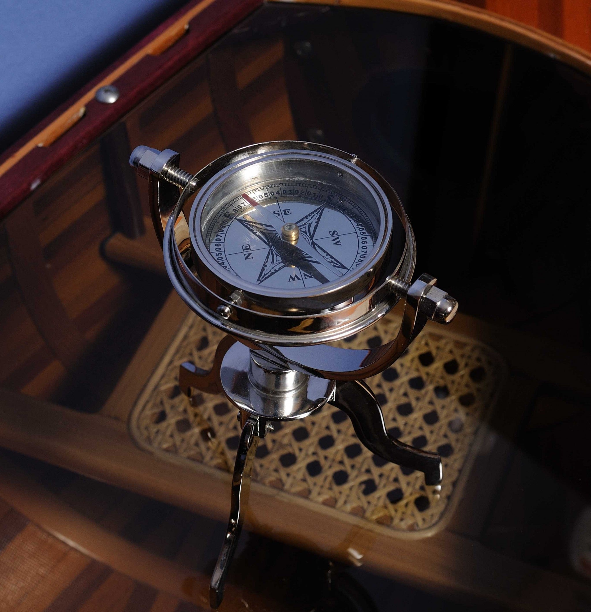 5 inches x 5 inches x 8.5 inches gimbaled compass on a solid brass tri-stand, showcasing a silver tinted finish and intricate craftsmanship.