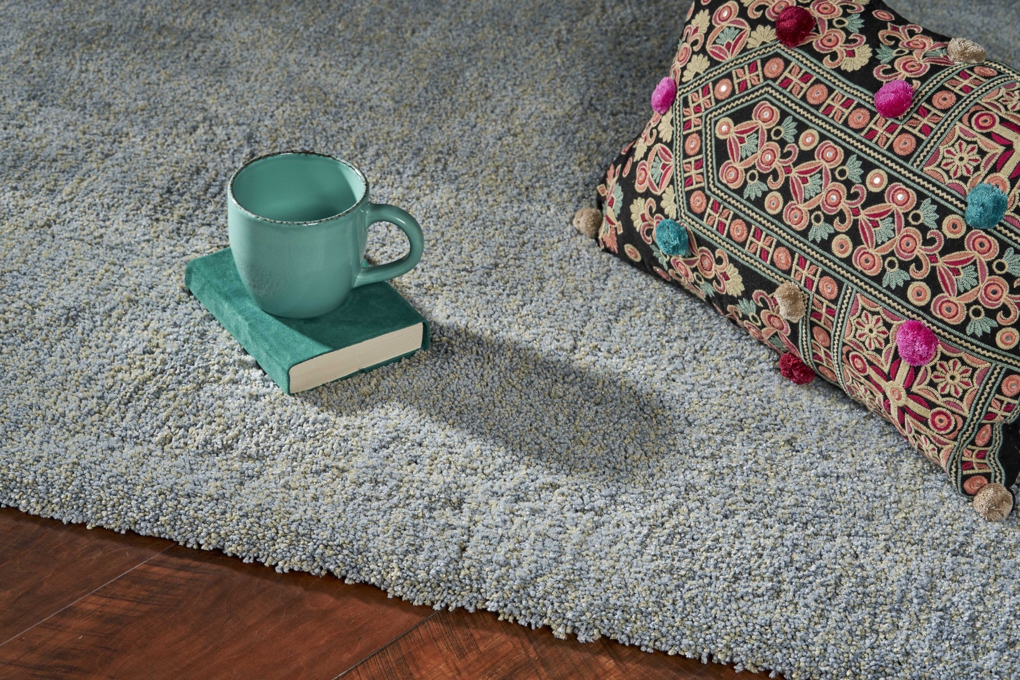 A 5x7 blue heather shag rug, hand woven from high-grade polyester with a soft texture and cotton backing, perfect for indoor use.