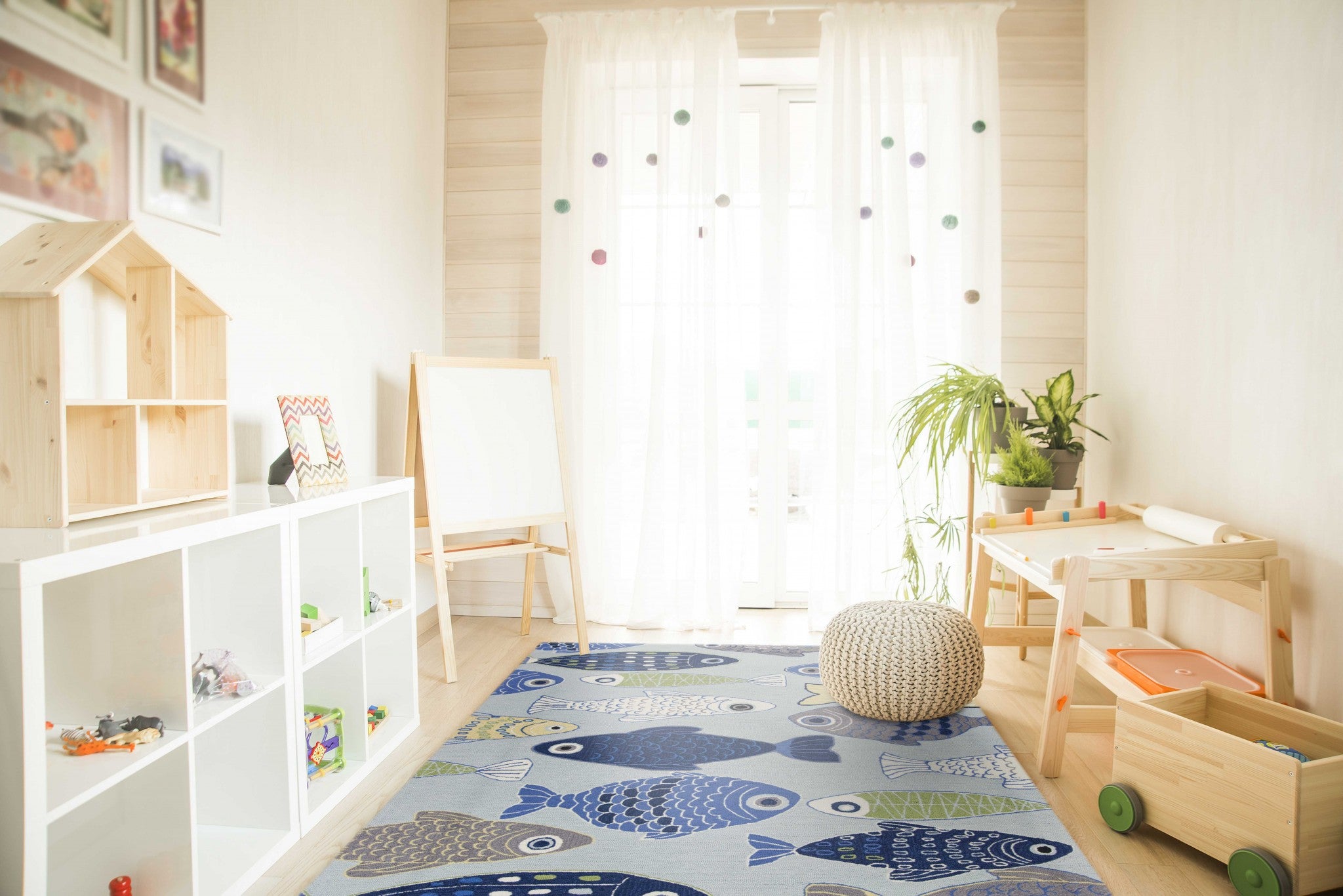 Light blue indoor area rug featuring a school of fish design, hand-hooked with polyester and cotton backing, perfect for modern home decor.