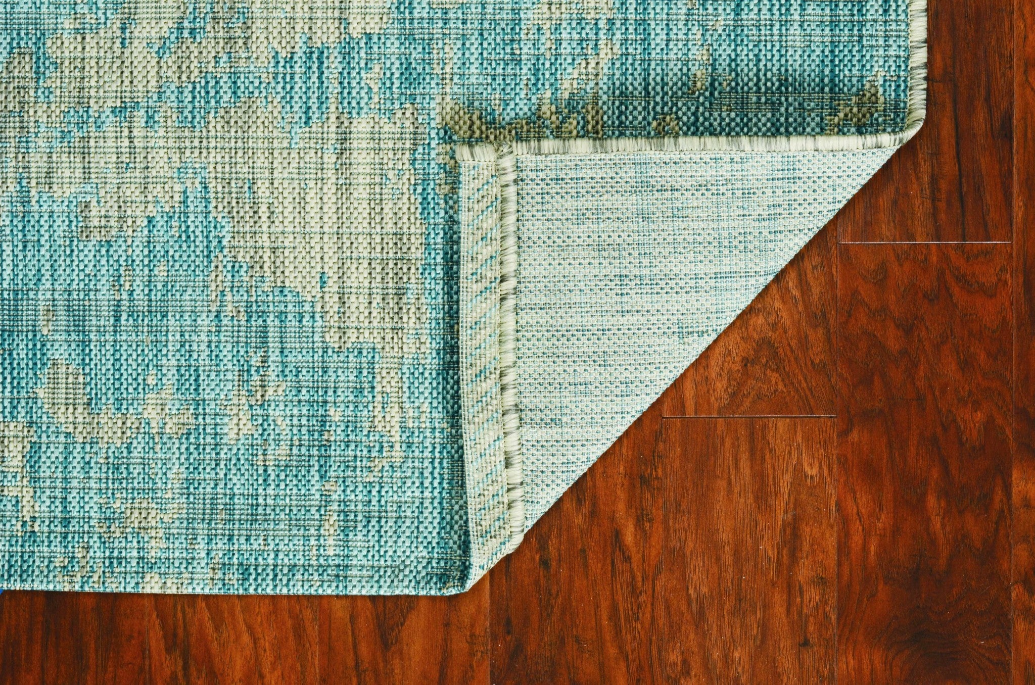 Teal machine woven abstract brushstrokes rug, perfect for indoor and outdoor use, showcasing vibrant colors and modern design.