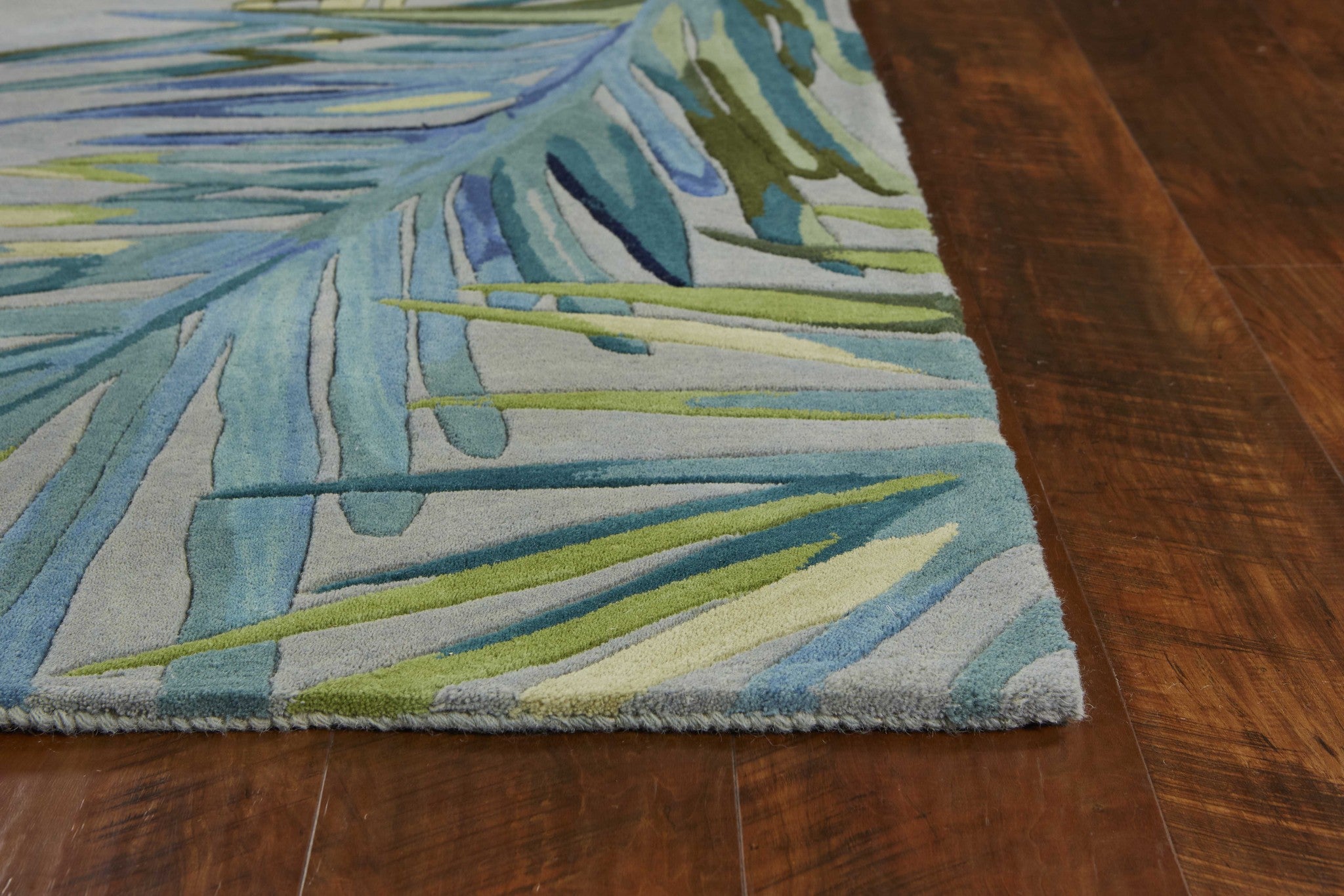 5x8 Grey Blue Hand Tufted Tropical Palms Indoor Area Rug featuring a tropical design with soft wool texture.