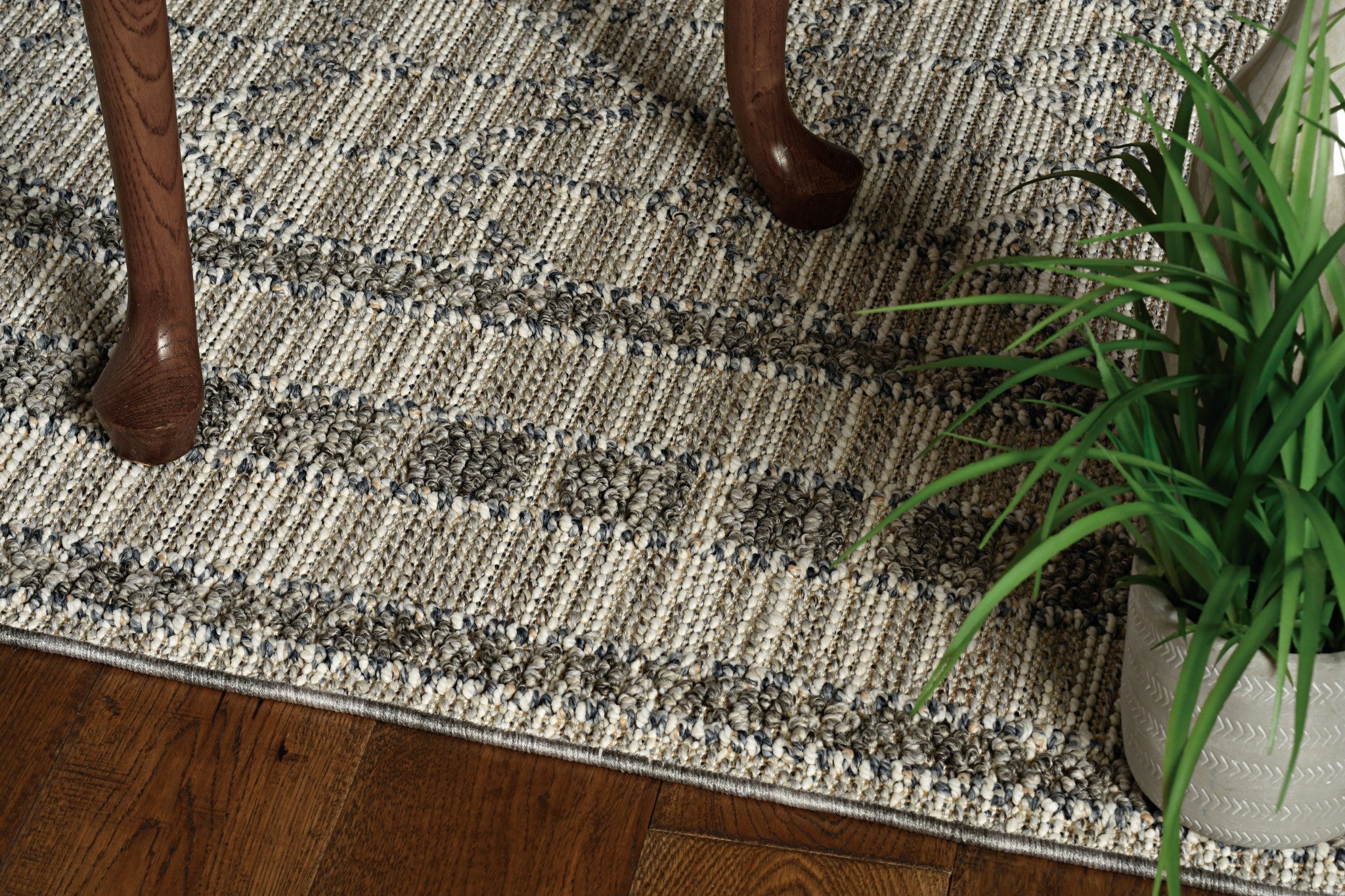 5x8 grey machine woven rug with bordered edges, suitable for indoor and outdoor use, showcasing a modern design.