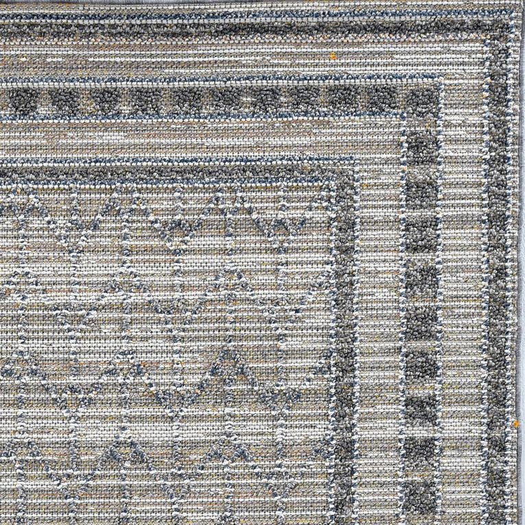 5x8 grey machine woven rug with bordered edges, suitable for indoor and outdoor use, showcasing a modern design.