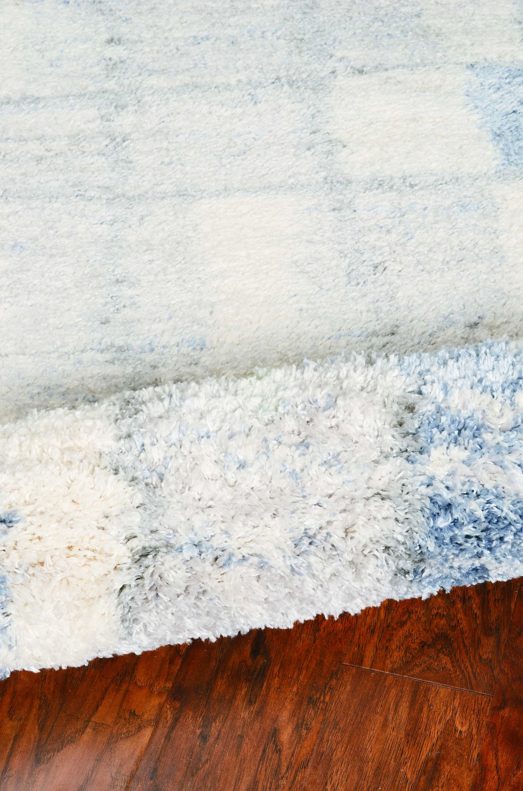 5x8 ivory blue machine woven abstract blocks indoor area rug showcasing modern design and soft textures.