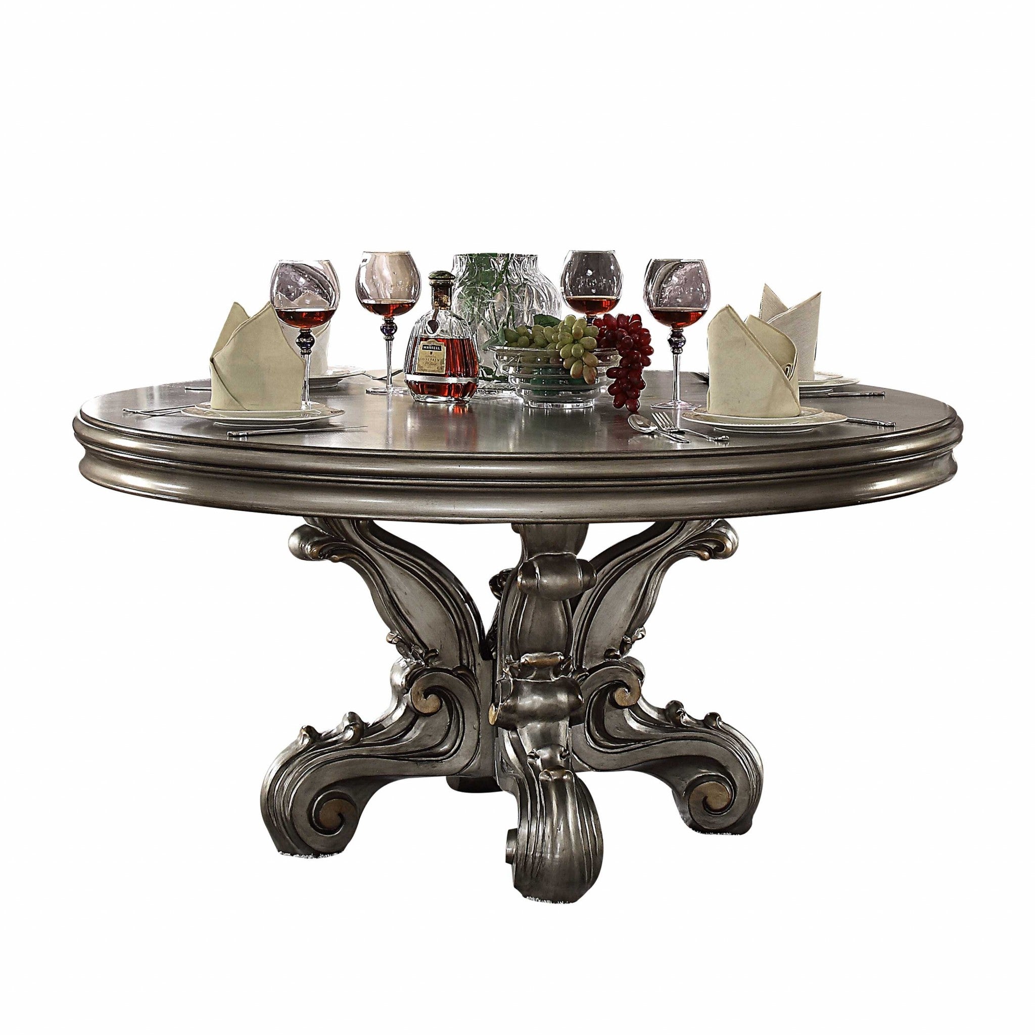Antique Platinum Wood Poly Resin Dining Table with intricate carvings and a round pedestal design, showcasing a stunning antique platinum finish.
