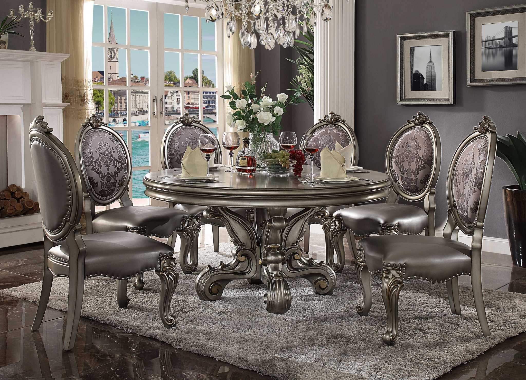 Antique Platinum Wood Poly Resin Dining Table with intricate carvings and a round pedestal design, showcasing a stunning antique platinum finish.