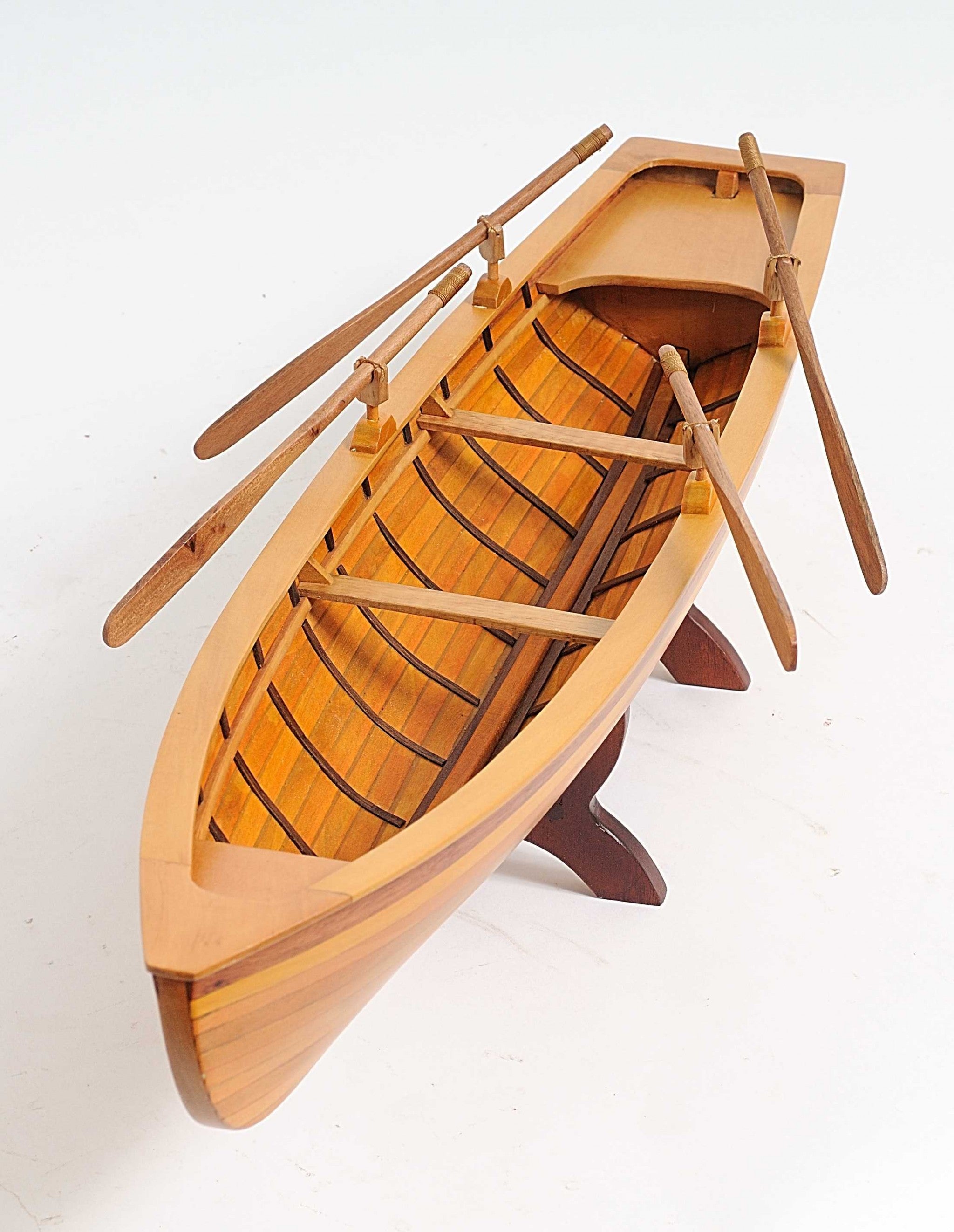 A beautifully crafted 6in x 24.5in x 6in wooden replica of a Boston Whitehall Tender rowing boat, showcasing intricate details and craftsmanship.