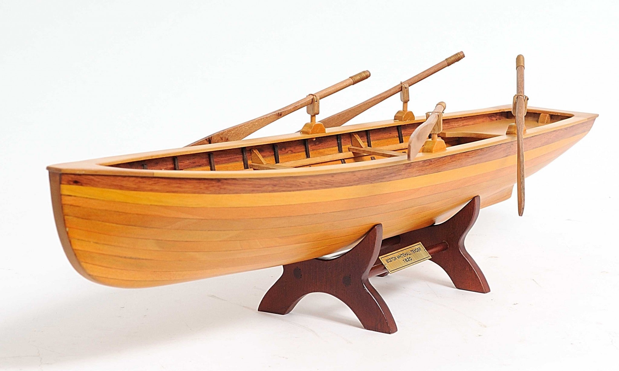 A beautifully crafted 6in x 24.5in x 6in wooden replica of a Boston Whitehall Tender rowing boat, showcasing intricate details and craftsmanship.
