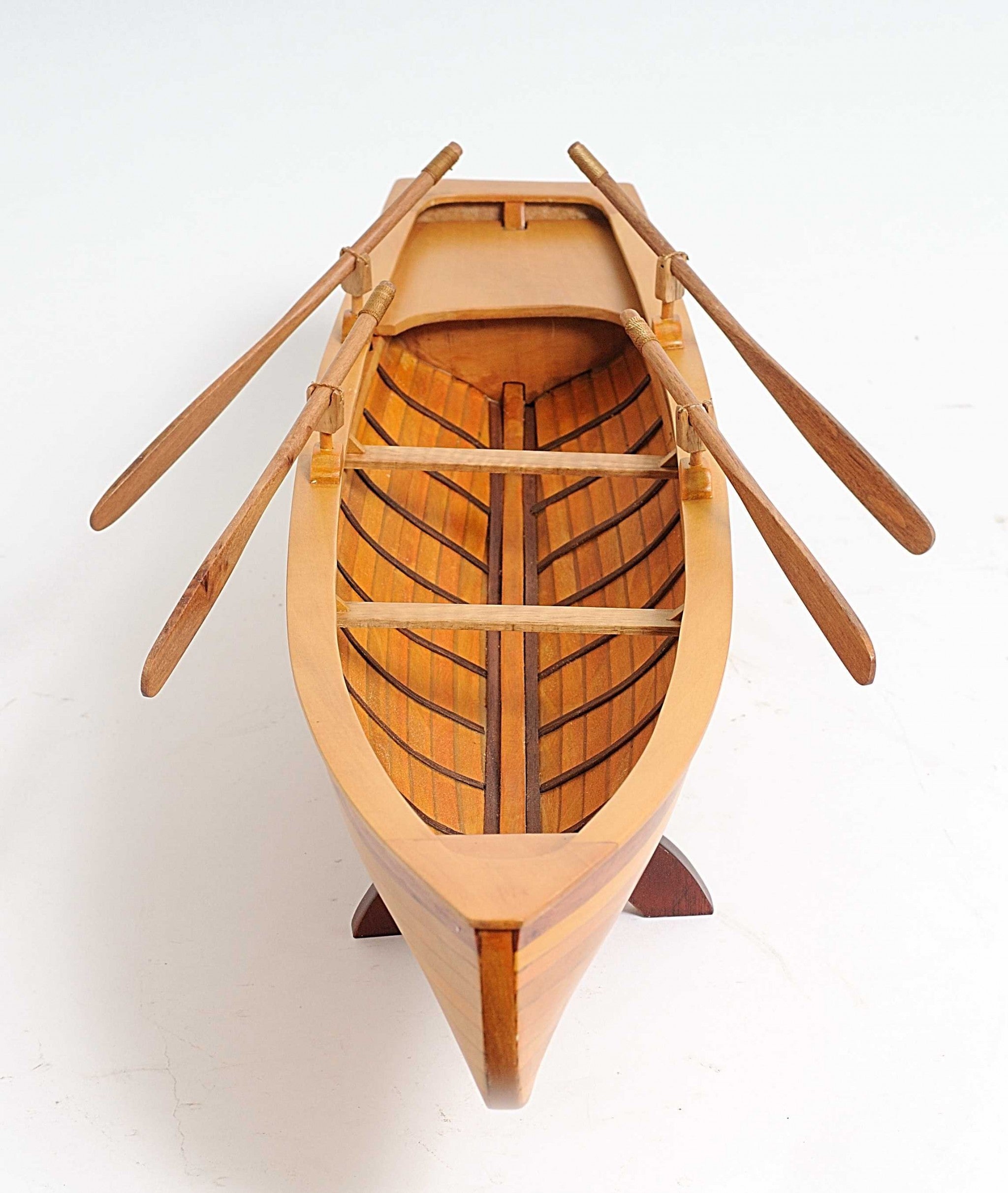 A beautifully crafted 6in x 24.5in x 6in wooden replica of a Boston Whitehall Tender rowing boat, showcasing intricate details and craftsmanship.