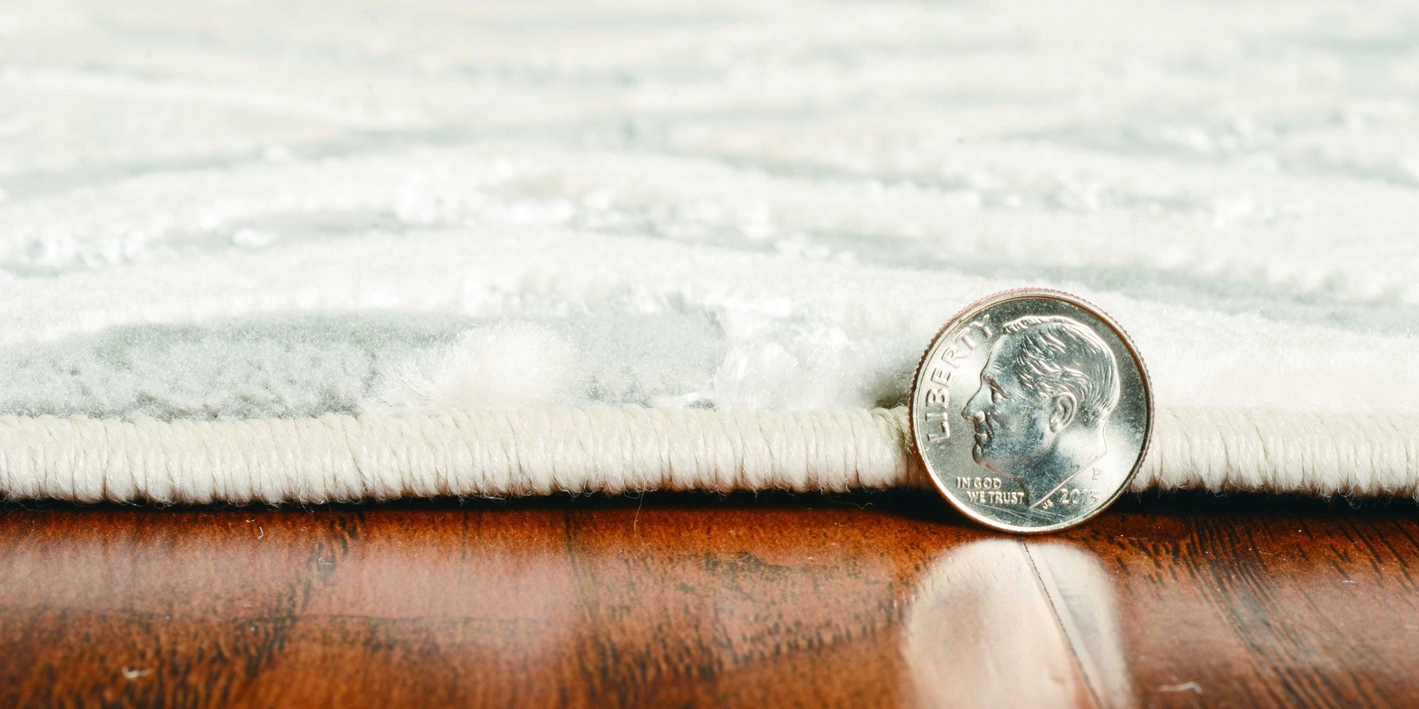 A stylish 6x9 inches Polyester Sand Silver Area Rug featuring modern paint-dripping effects and layered designs, perfect for contemporary decor.