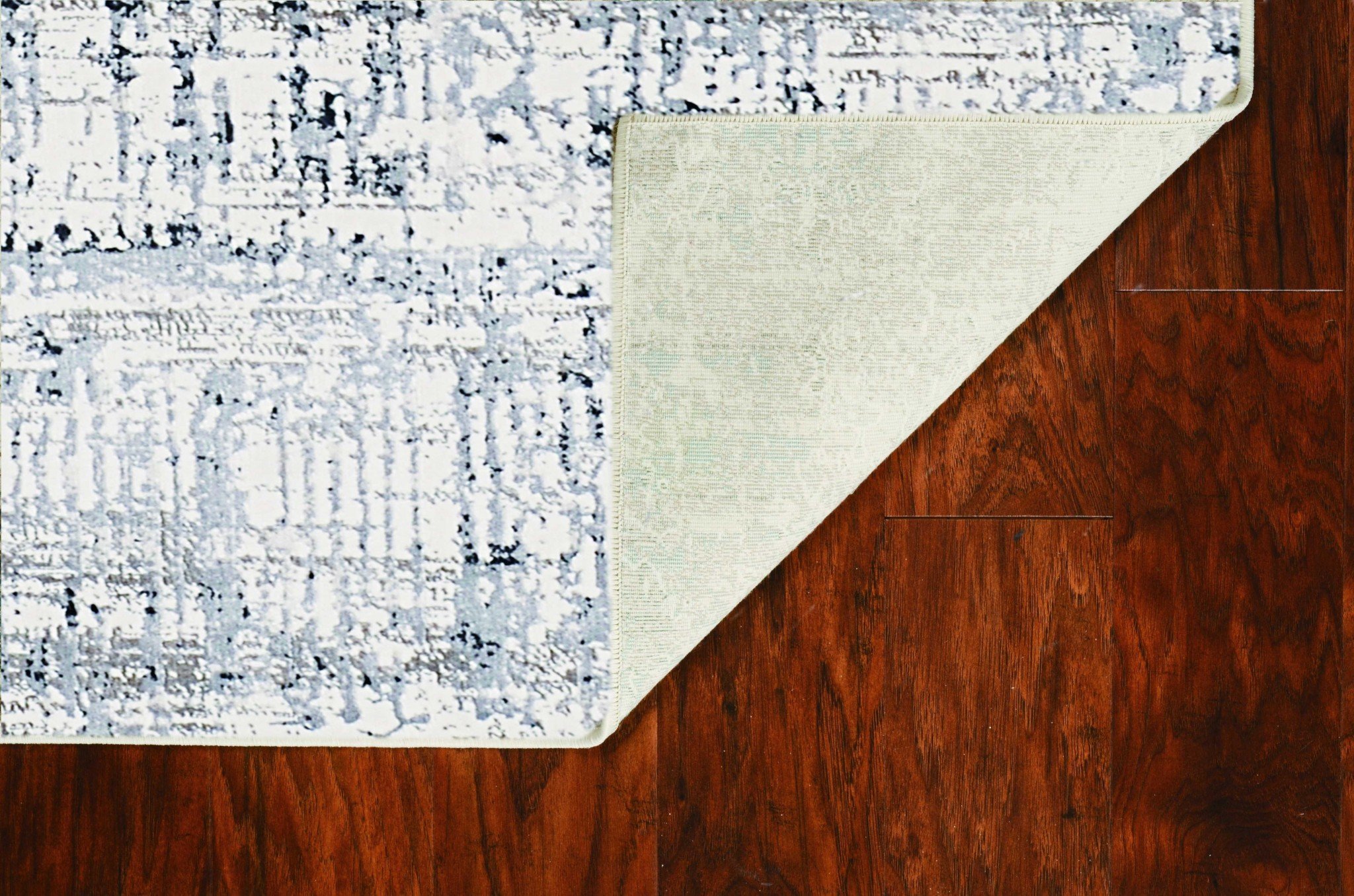 7' x 11' ivory and silver area rug with a modern metallic luster, showcasing a luxurious design suitable for various home decors.