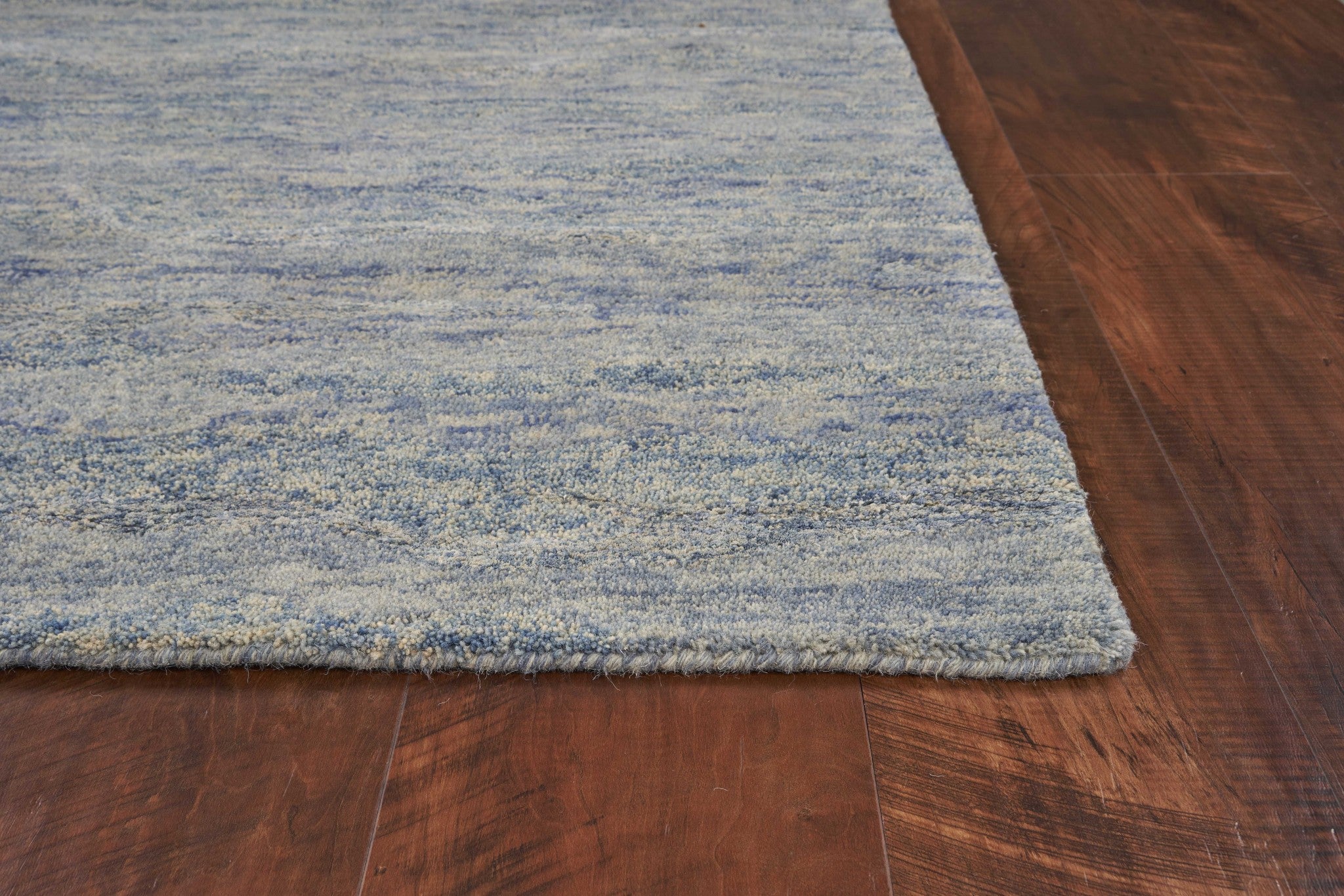 A luxurious 7 x 9 ocean blue area rug made from wool and viscose, showcasing a modern design with soft textures, perfect for enhancing living spaces.